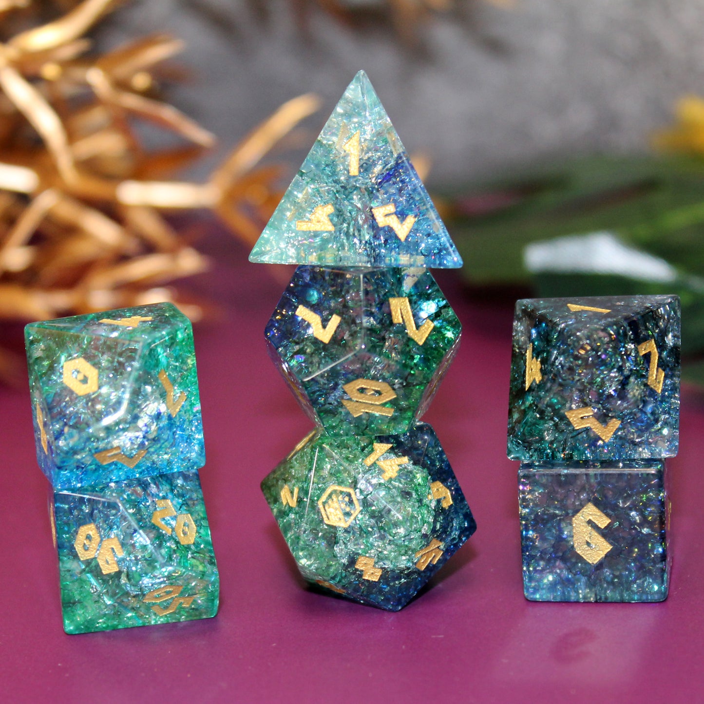 Stacked glass dice set showing deep blues and greens, ideal for DnD gameplay and frost-themed adventures.