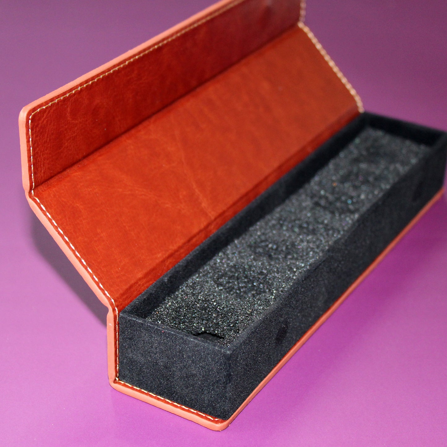 Fully open Brown PU Leather Rectangular Dice Case, displaying the 7 foam-lined compartments designed to cradle each die in a standard RPG set.