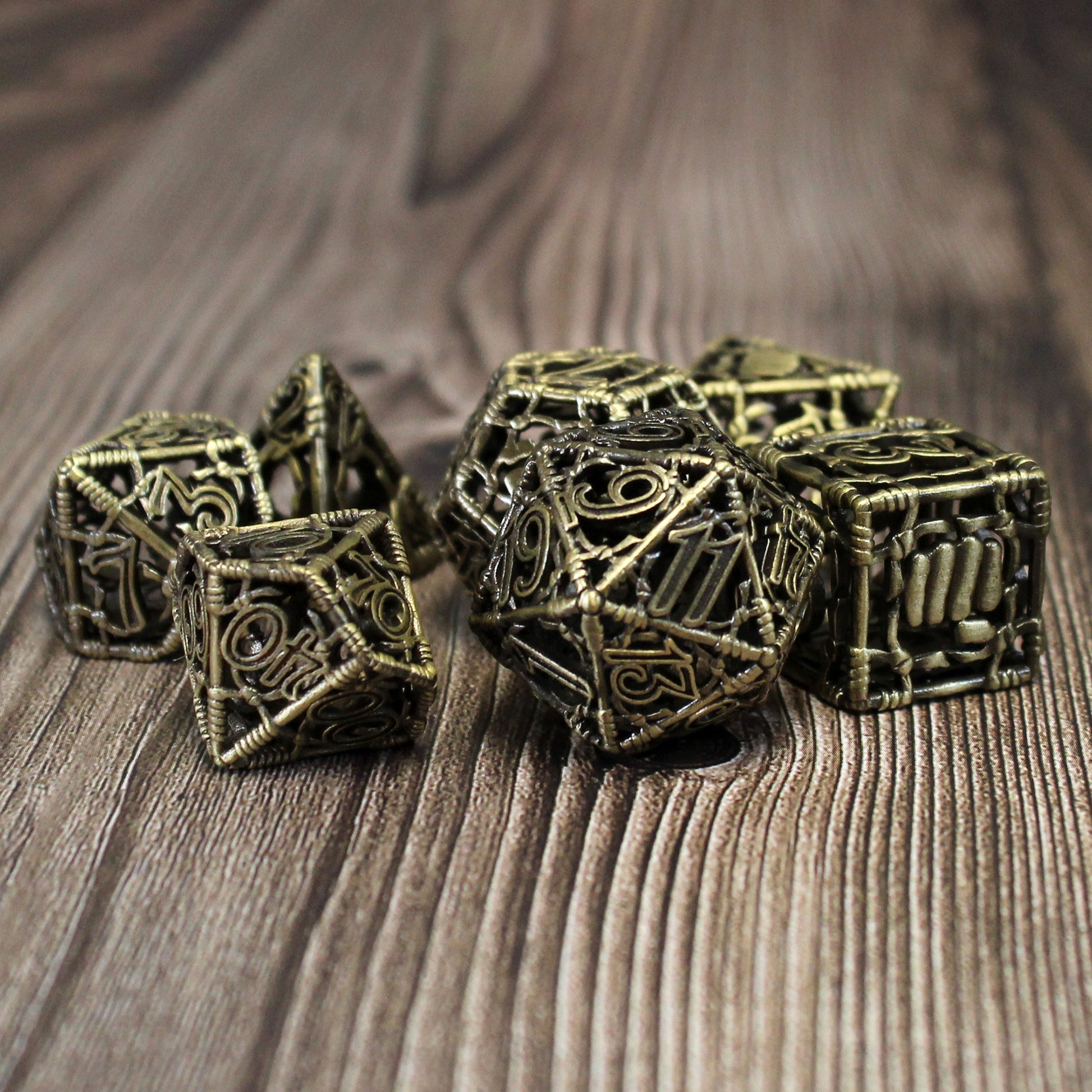 All 7 bronze dice on a wood paneled surface