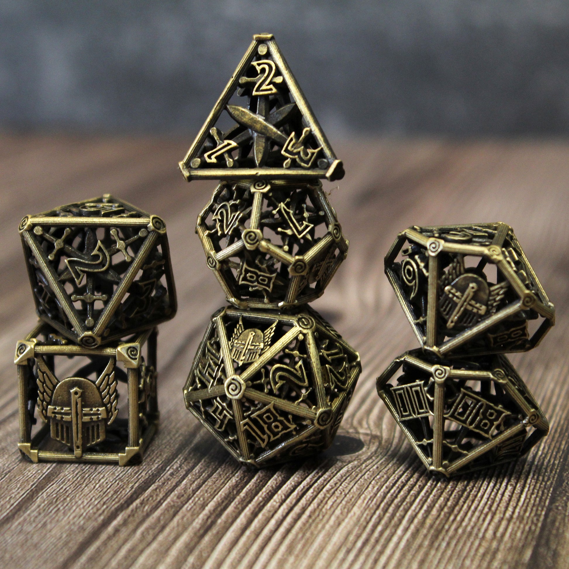 All 7 bronze dice piled up in 3 stacks. Two dice in first stack, three dice in second stack, two dice in third stack. All on a wood paneled surface with a grey background.