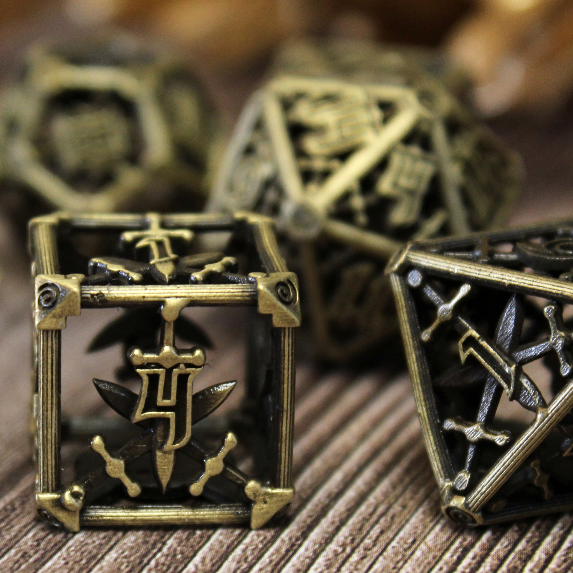 Up close image of 6 sided die, with three other die partially in view and blurred in background. On wood paneled surface.