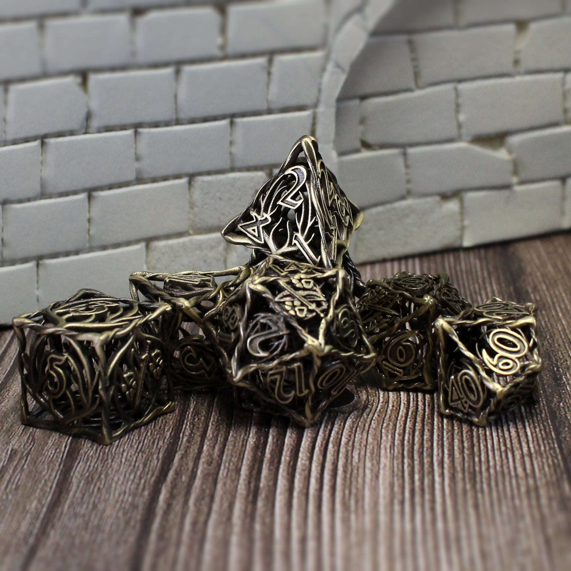 Bronze Ranger dice arranged in a pile on a wood surface with white brick wall set pieces in the background. The D4 die has been placed on top.