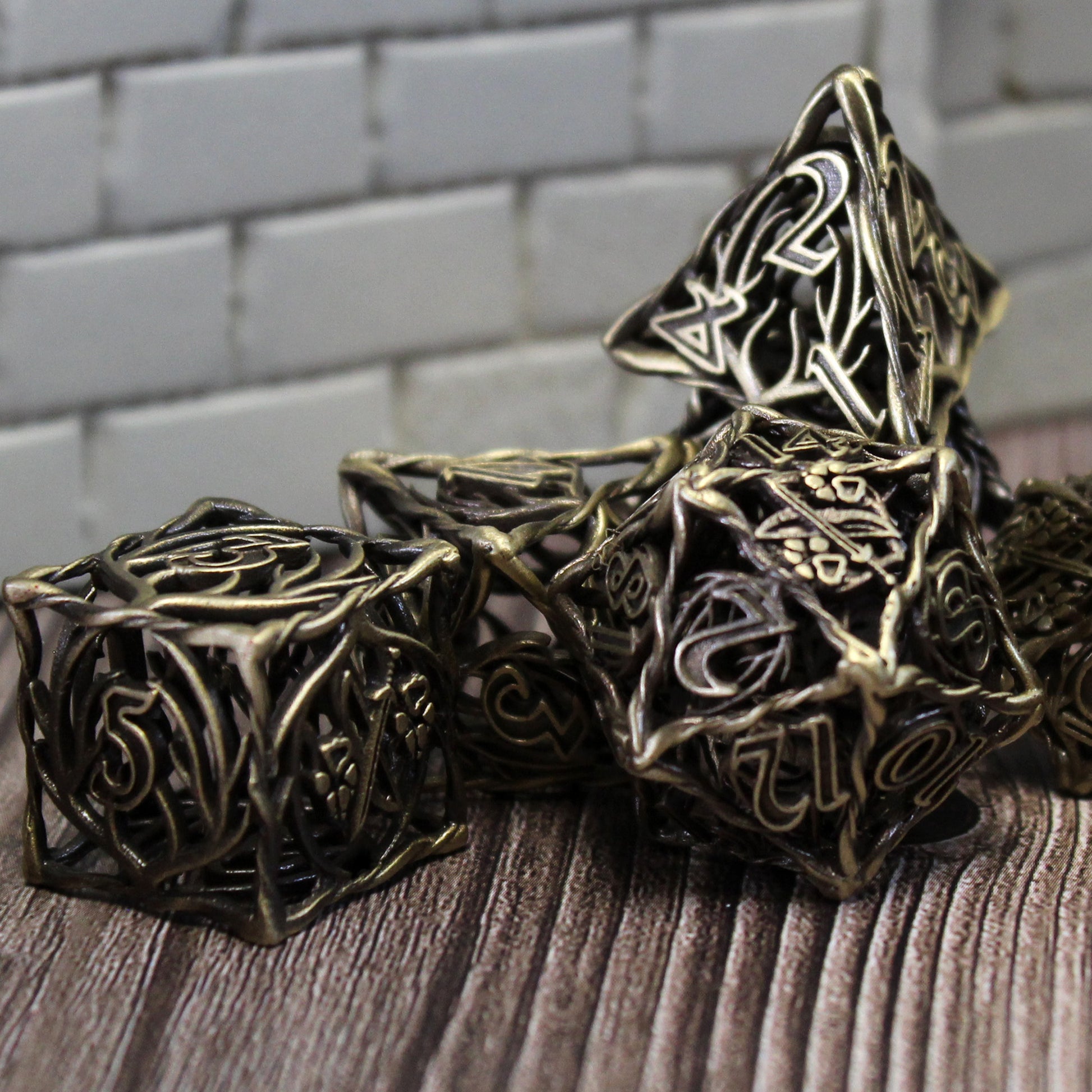 Bronze Ranger dice arranged in a pile on a wood surface with white brick wall set pieces in the background.
