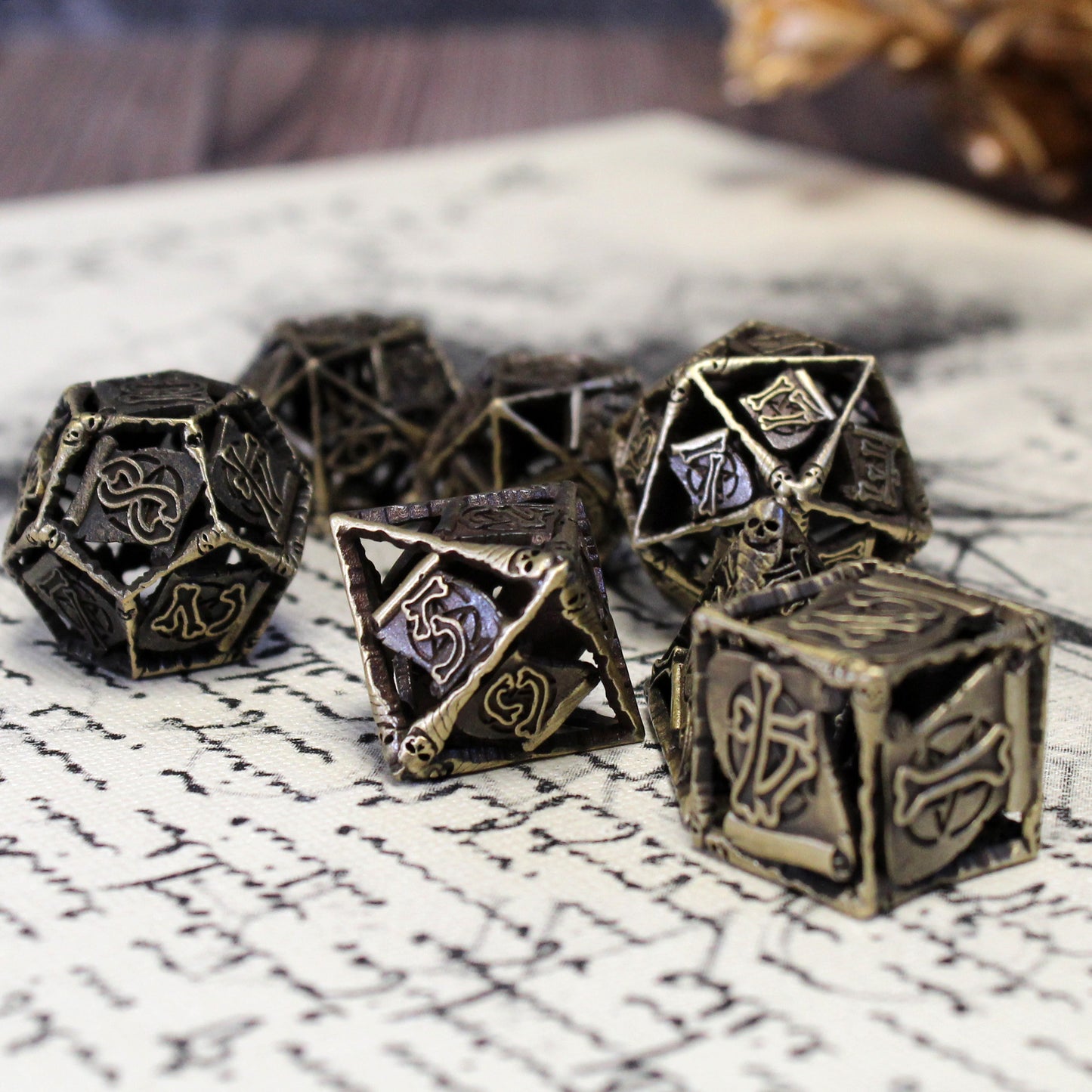 Warlock Cage Dice Set in bronze, displayed on a book of ancient text resembling a patron contract, highlighting the crossed bone font and demonic sigil design.