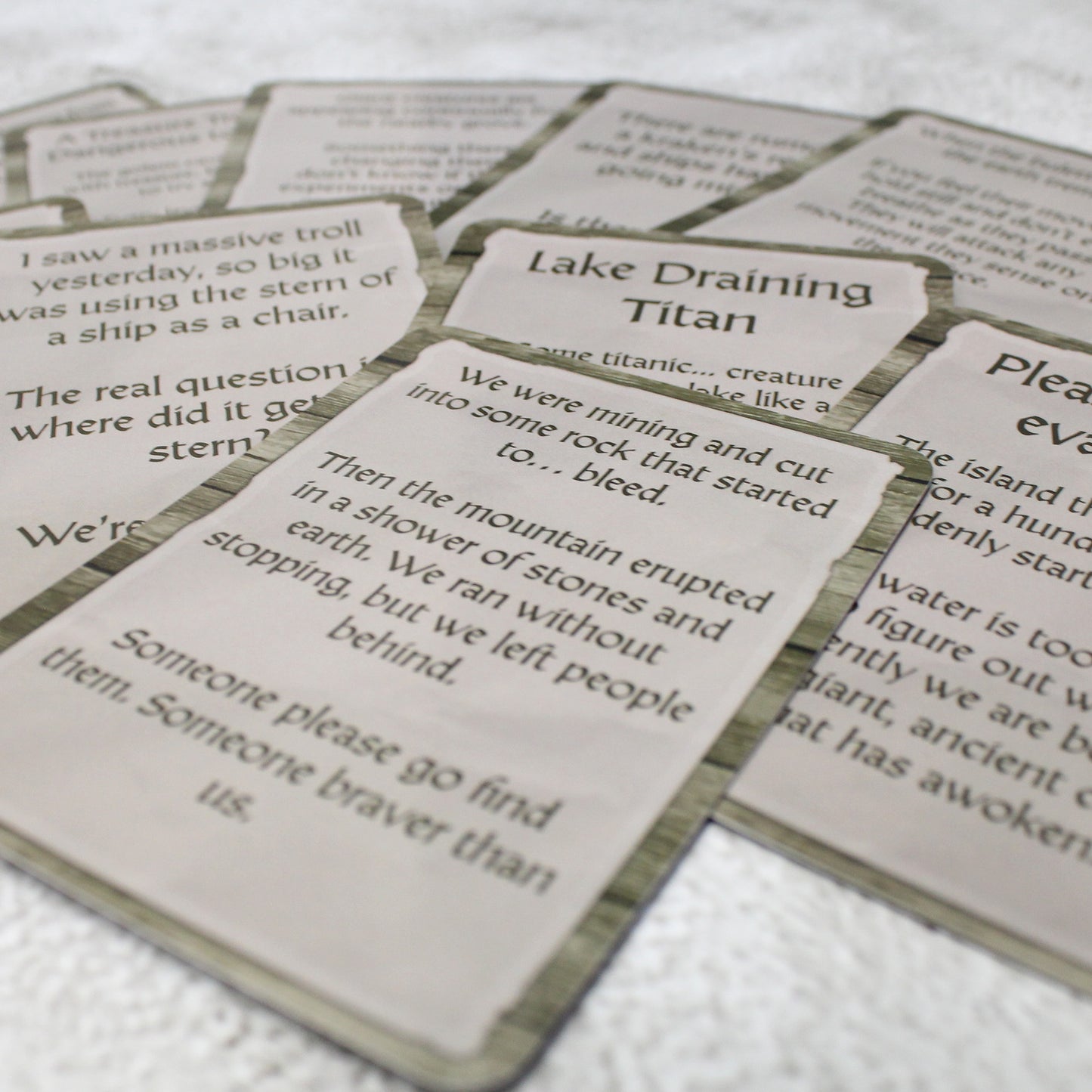 An array of Colossal Terrors quest cards laid out, featuring unique quest starters for tracking and confronting colossal monsters in your RPG world.