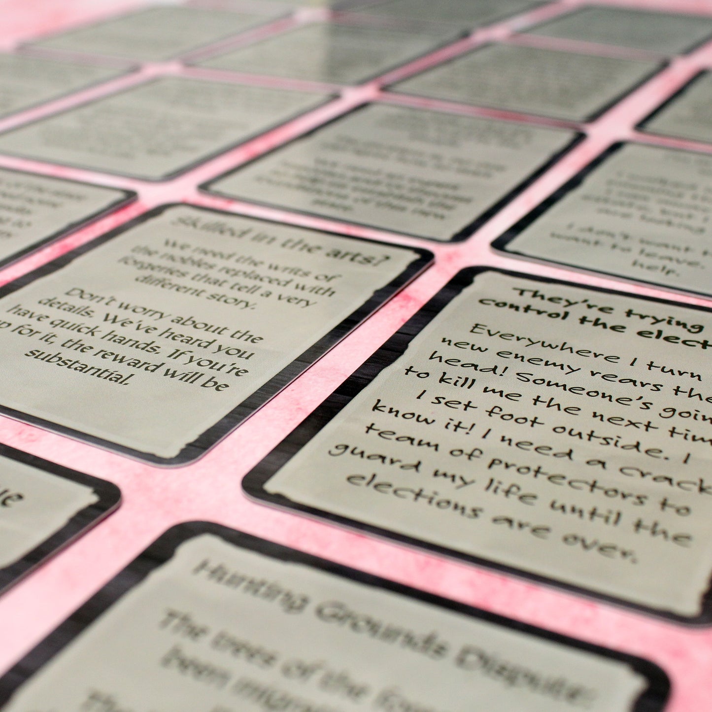A closeup photo of cards from the Emissaries & Infiltrators Quest Deck featuring a card in a non-serif font.