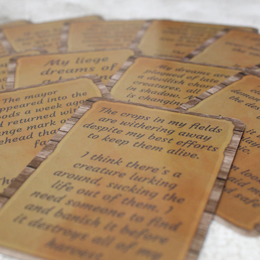 Photo of a spread of cards from the deck presented as paper posters on a wooden background with the text of the posting in an italicized font.