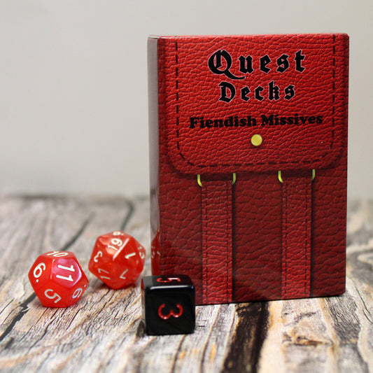 Photo of Quest Deck: Fiendish Missives physical deck box on a wooden surface with dice on a white background.  Fiendish Missives focuses on demonic cults, secret sects, and otherworldly pacts.