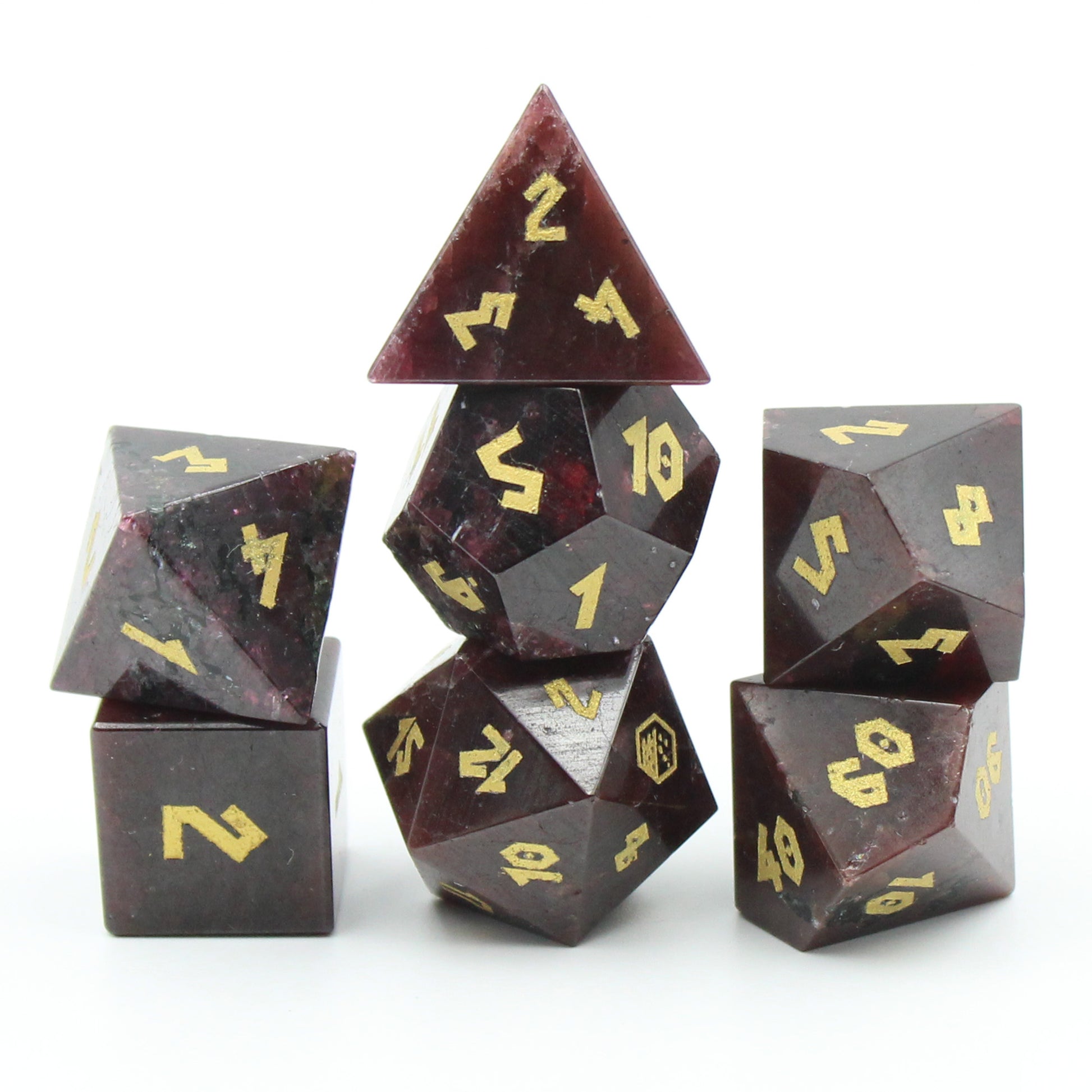Stacked Garnet gemstone dice set, highlighting the deep red color and exclusive gold numbering.