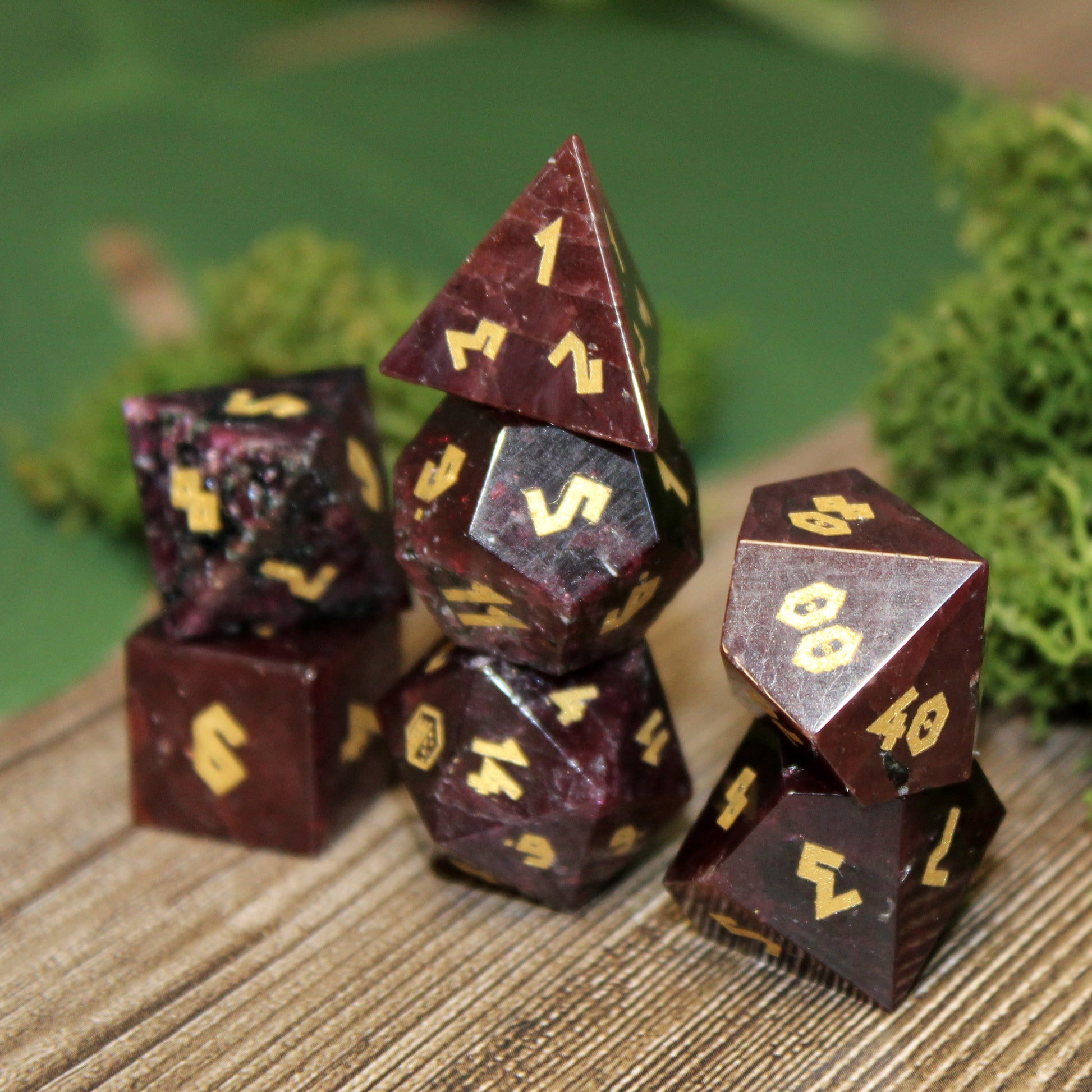 Stacked Garnet gemstone dice set. Deep red with gold-color numbers.