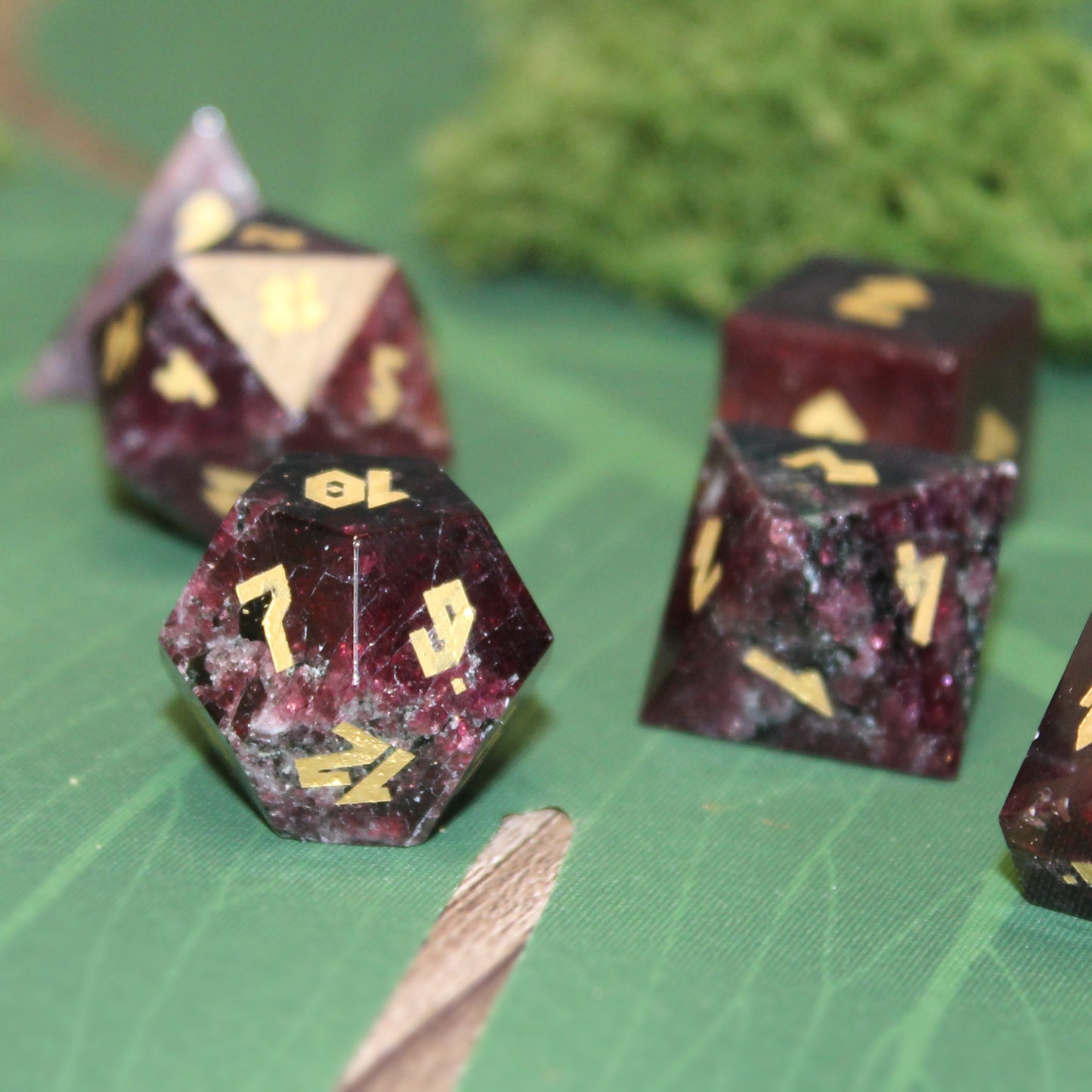 Close-up of Garnet D12, featuring the luxurious brownish-red gemstone.