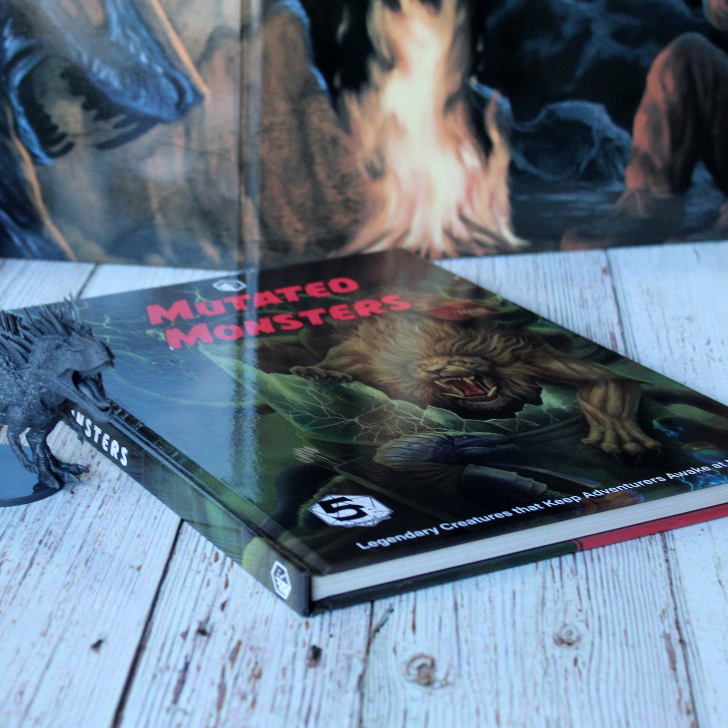Detailed shot of game book's glossy Hardcover next to miniature.