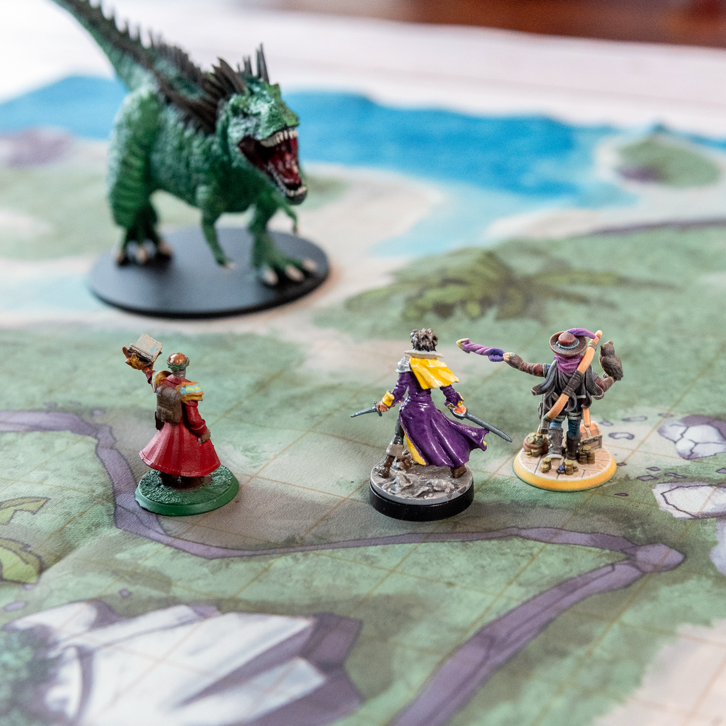 Photo of an island battle map with various miniature figures placed on it