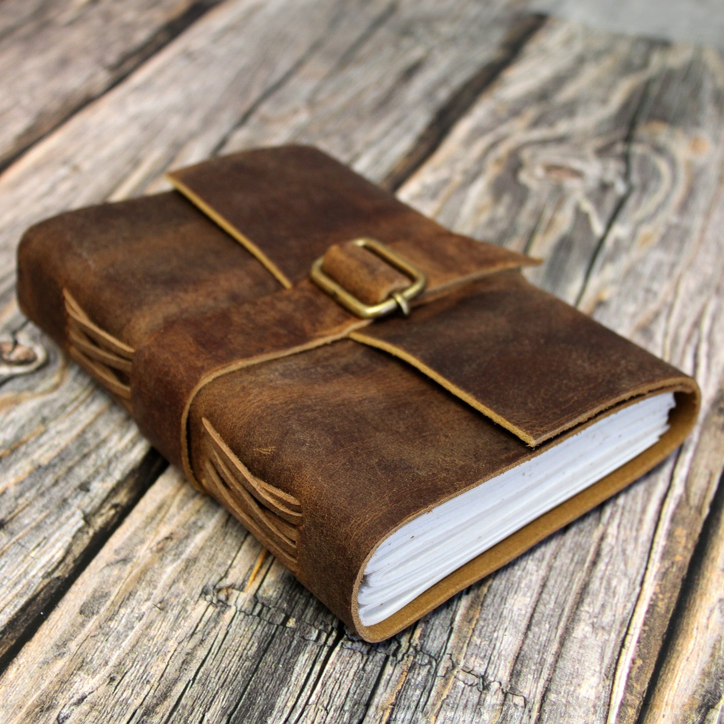 Leather bound journal with a strap that is perfect for notes in any TTRPG campaign setting