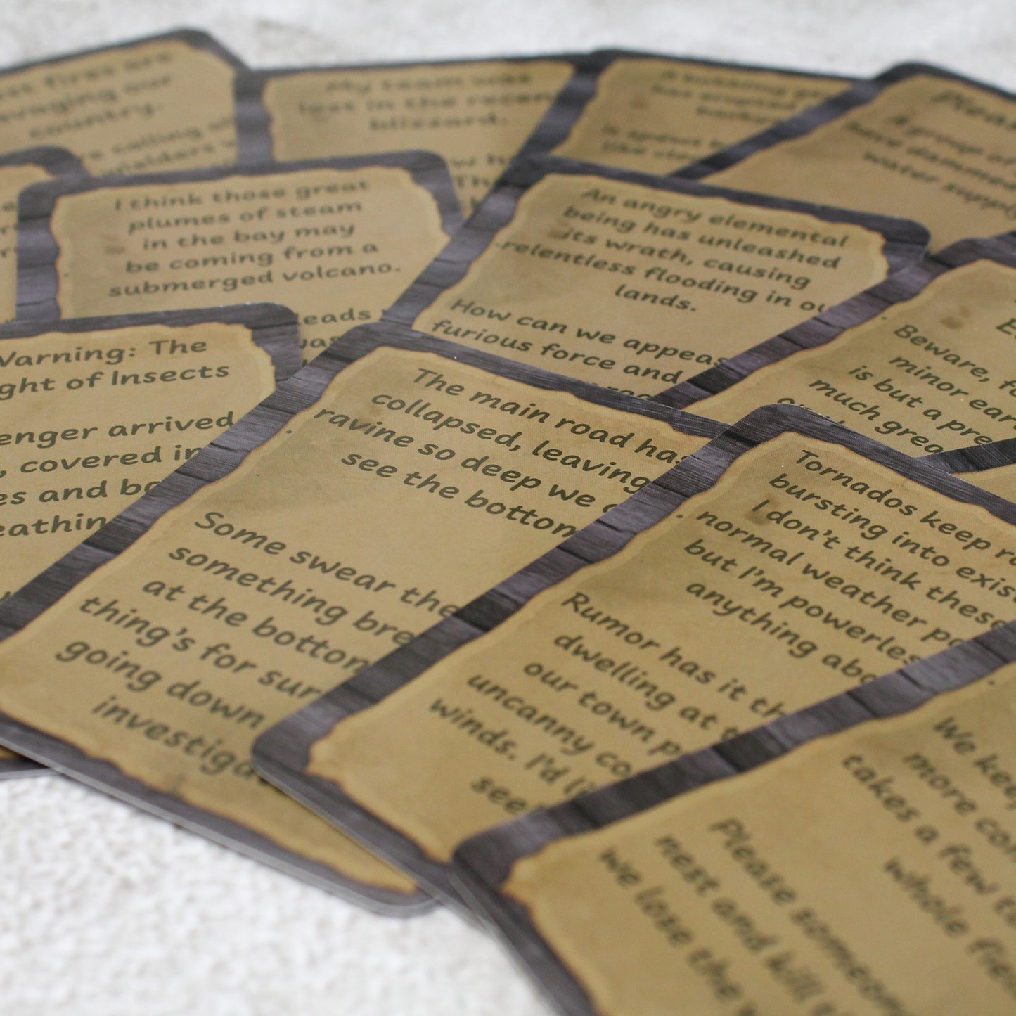 Photo of a spread of cards from the deck on a white background. Each card has a wood panel background with the contents of the posting in a handwritten font on a sheet of paper.
