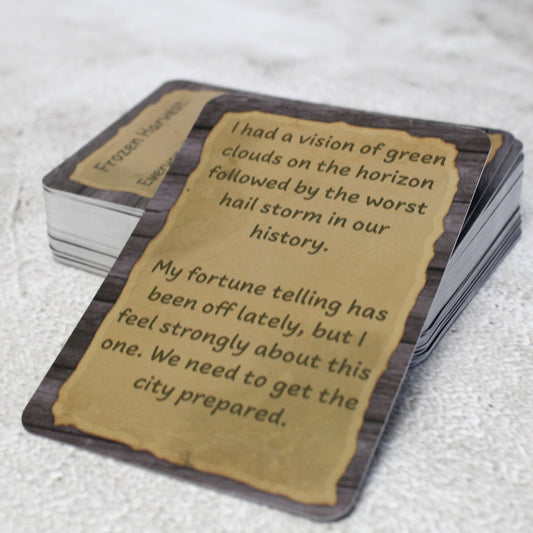 Photo of an example card from the deck on a white background that reads "I had a vision of green clouds on the horizon followed by the worst hail storm in our history.  
My fortune telling has been off lately, but I feel strongly about this one.  We need to get the city prepared."