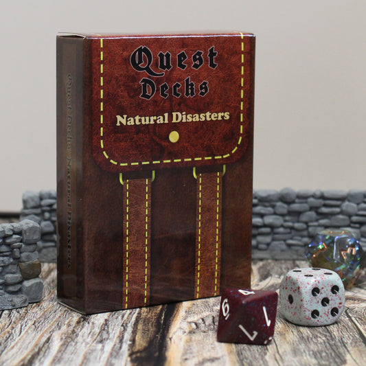 Photo of Quest Deck: Natural Disasters physical deck box on a wooden surface with dice and walls with a white background.  Natural Disasters focuses on the forces of nature as an opponent for your players.