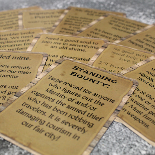 Spread of Notice Board 2 cards overlapping on a stone surface.
The top card reads, "Standing Bounty: 
Large reward for anyone who figures out the identity of and/or captures the armed thief who has been robbing travelers.  It is severely damaging tourism in our fair city!"