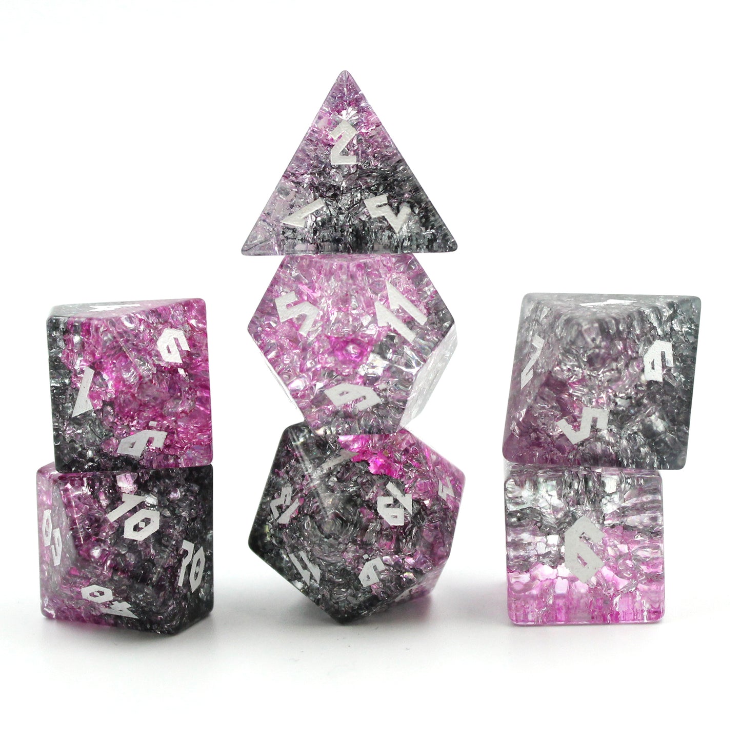 Shot of Glass dice set on white background highlighting the light refracting through pinks and black.
