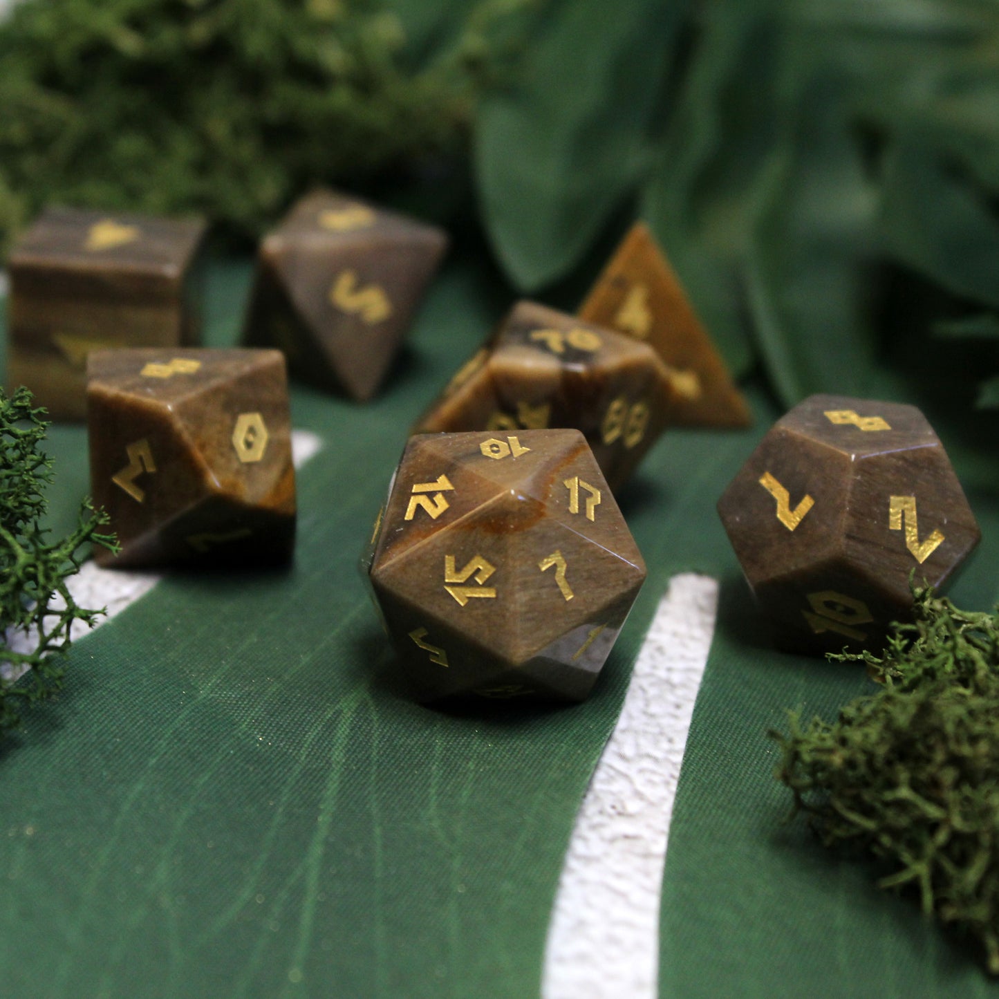 Dice set on green backdrop, emphasizing deep browns and gold numbers for immersive RPG gameplay.