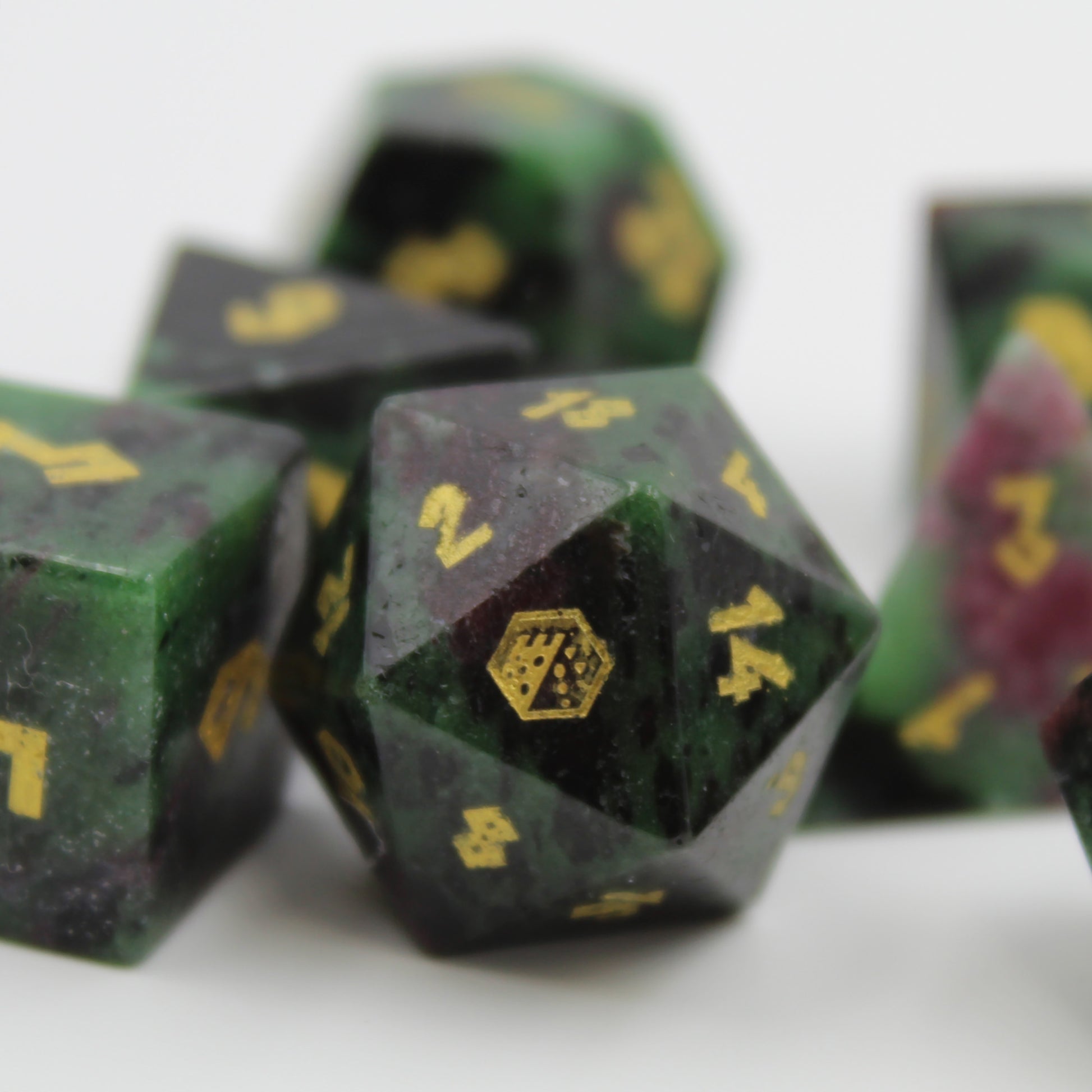 Close-up of the D20 die from the Ruby Zoisite set, featuring natural gemstone patterns for an enhanced tabletop RPG experience.