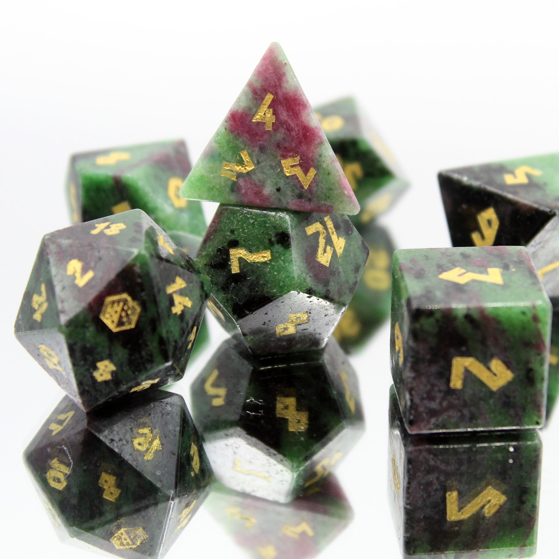 Group shot of Ruby Zoisite dice on a mirror - showcasing intricate details and elegance for your tabletop games.