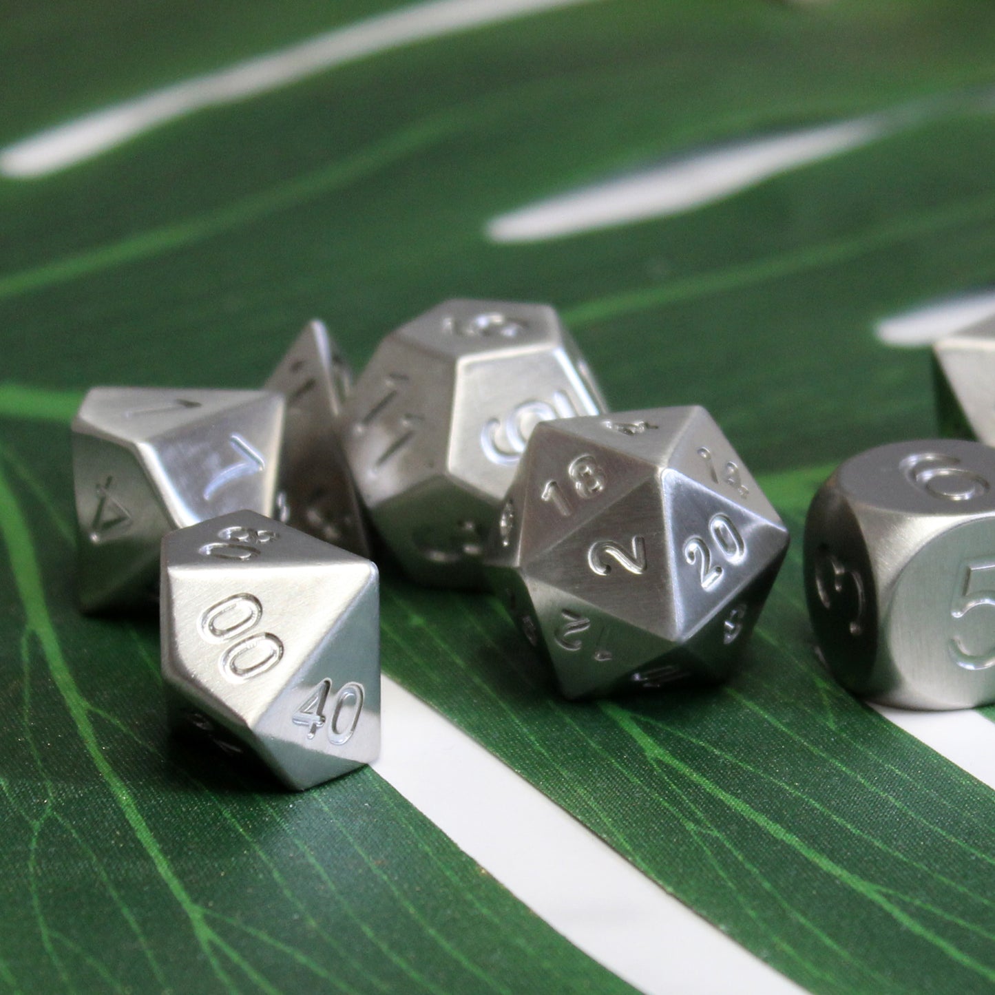 stainless steel dice arrays on contrasting background showing the unique special metal in this luxury dice set.