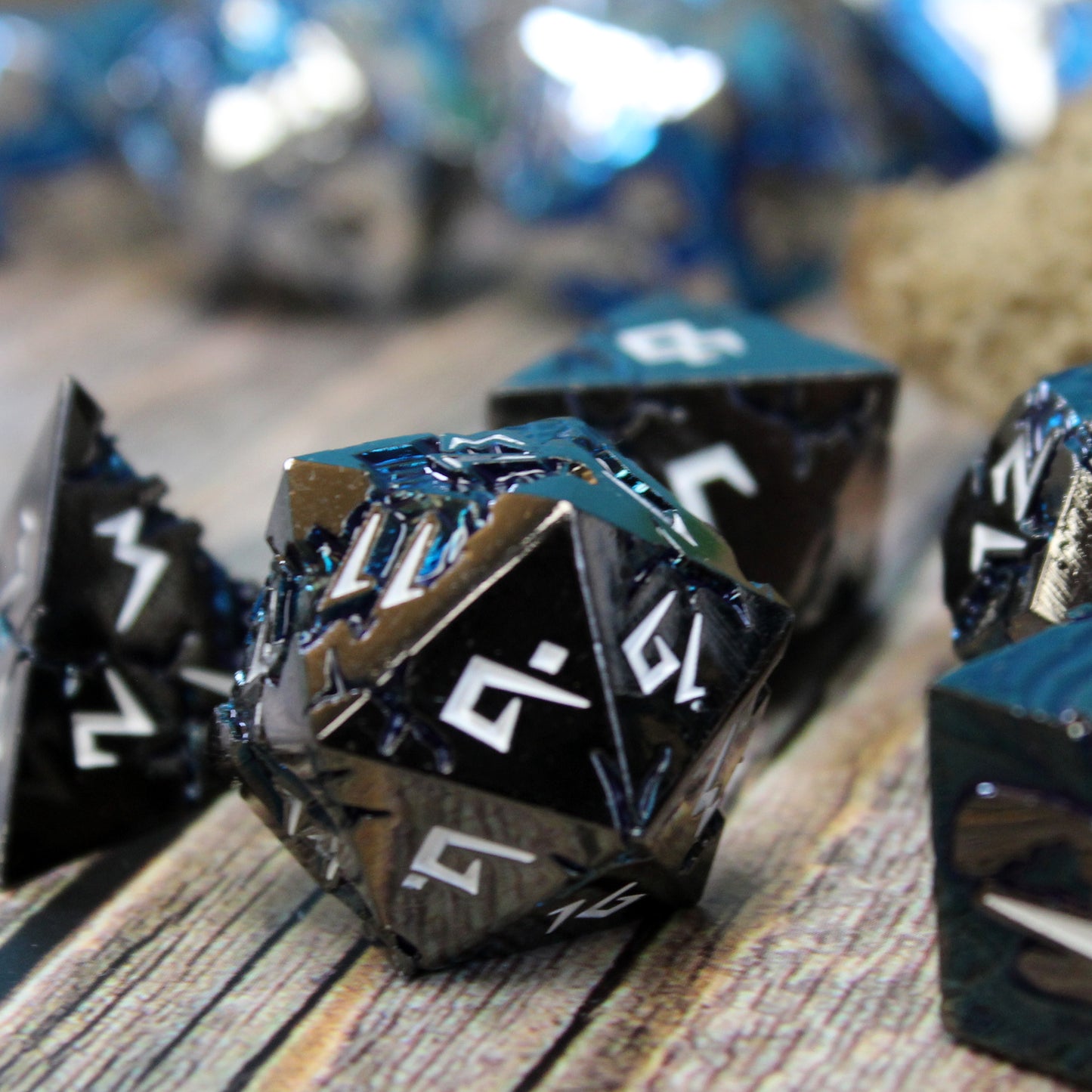Close-up of Stormrift black nickel D20 on wood surface, showcasing deep blue scar pattern and jagged white numbers for D&D.