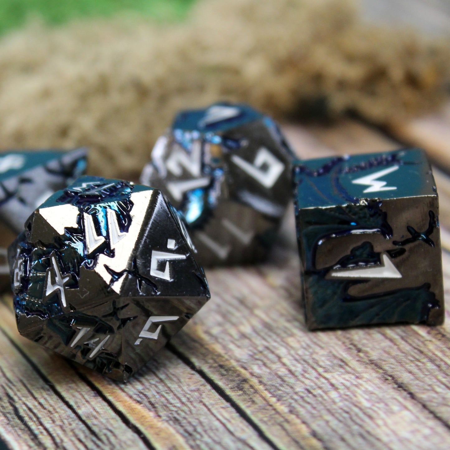 Stormrift black nickel metal dice set close-up on wood, with deep blue scar design and white font, ideal for tabletop gaming.