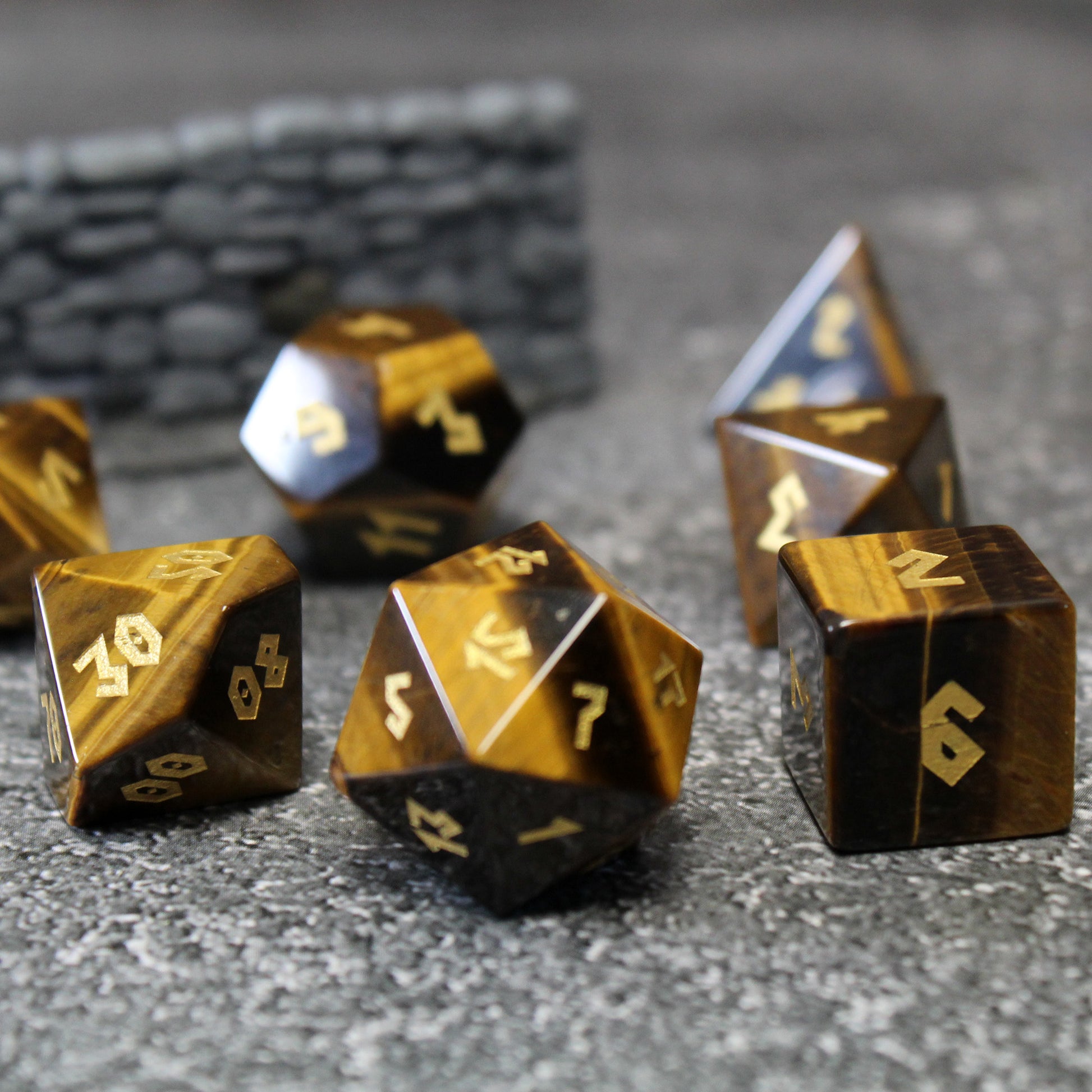 Tiger Eye dice set on a Dungeons & Dragons table.
