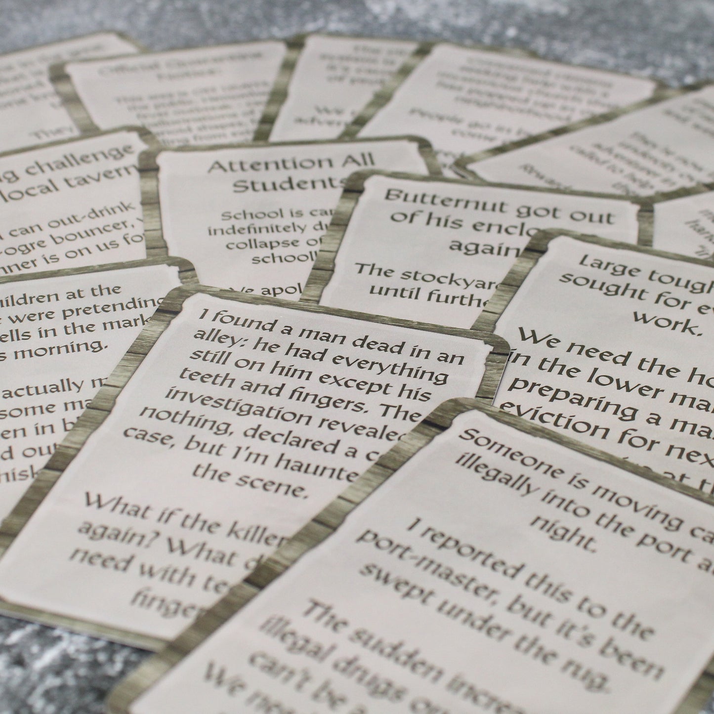 A photo of a spread of cards from the Urban Encounters deck overlapping each other on a stone background.