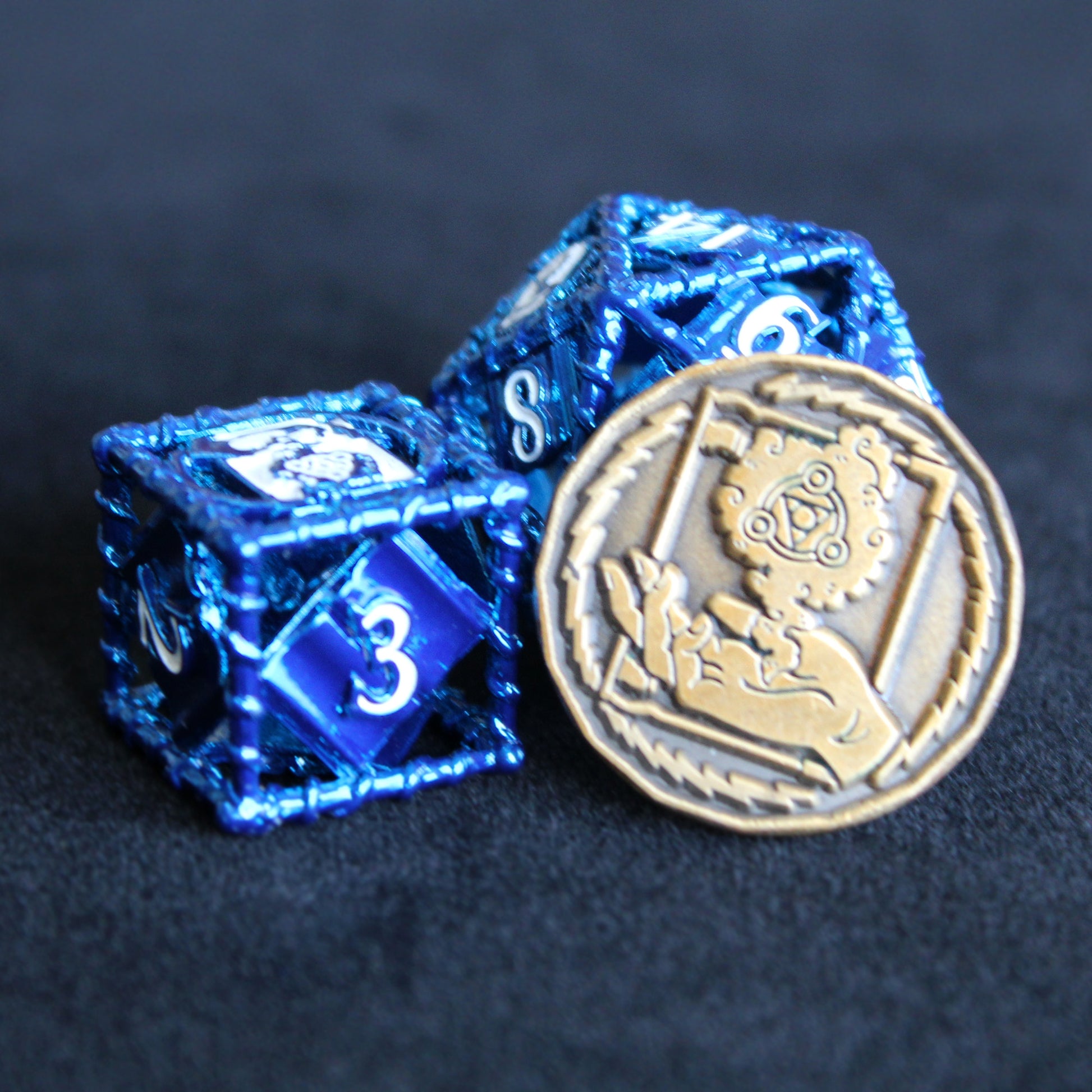 gold wizard character coin propped up on a blue 20 sided die, next to a blue 6 sided die. On a black background.