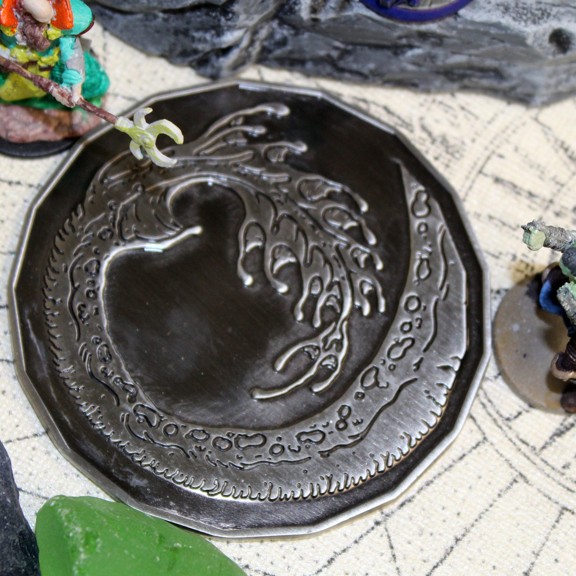 Tails side of the Adult Smoke Dragon monster token shown during an action-packed battle with miniatures, ready to be flipped as the dragon falls in combat, adding dynamic tension to the game.
