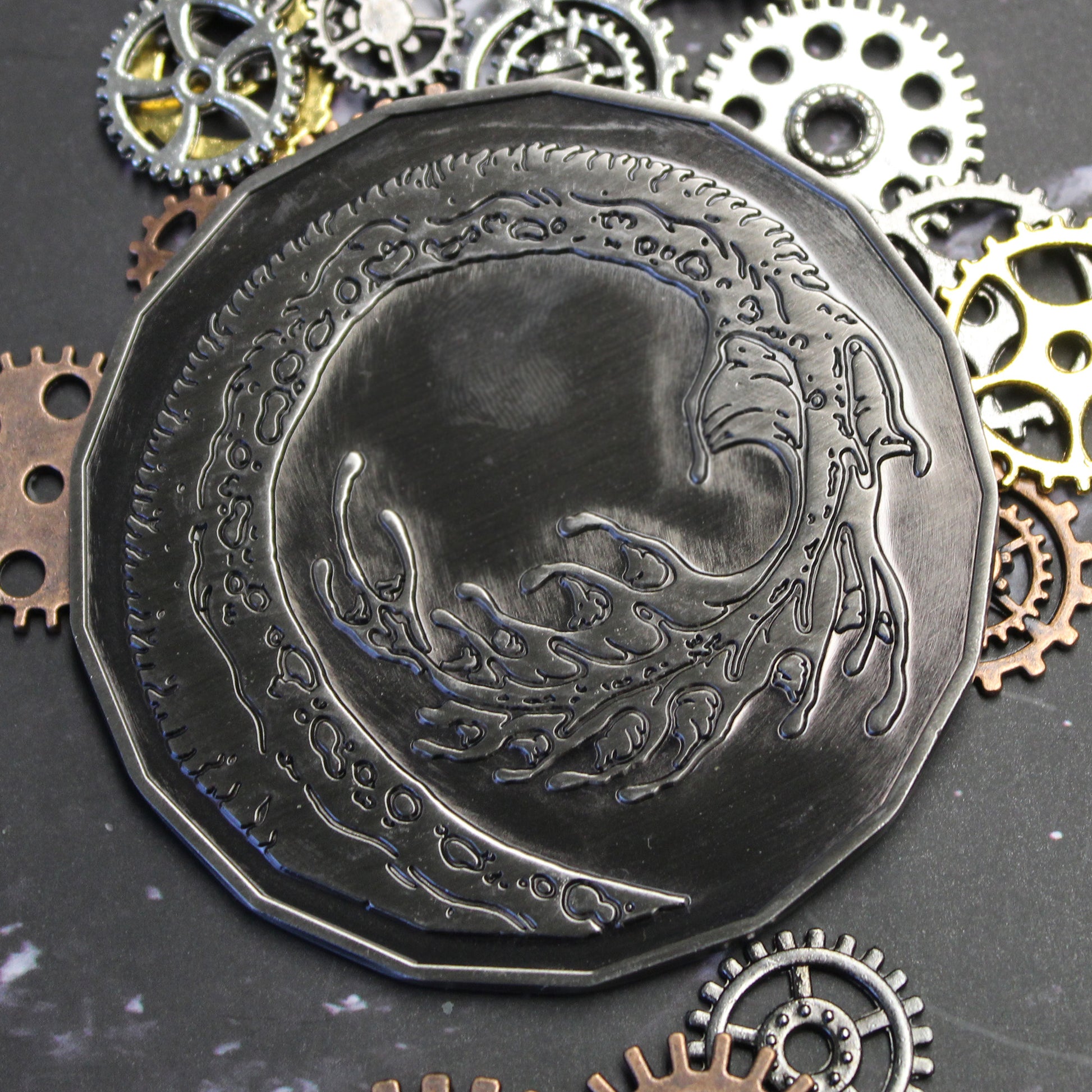 Adult Smoke Dragon monster token displayed tails-side up on a black marble background.