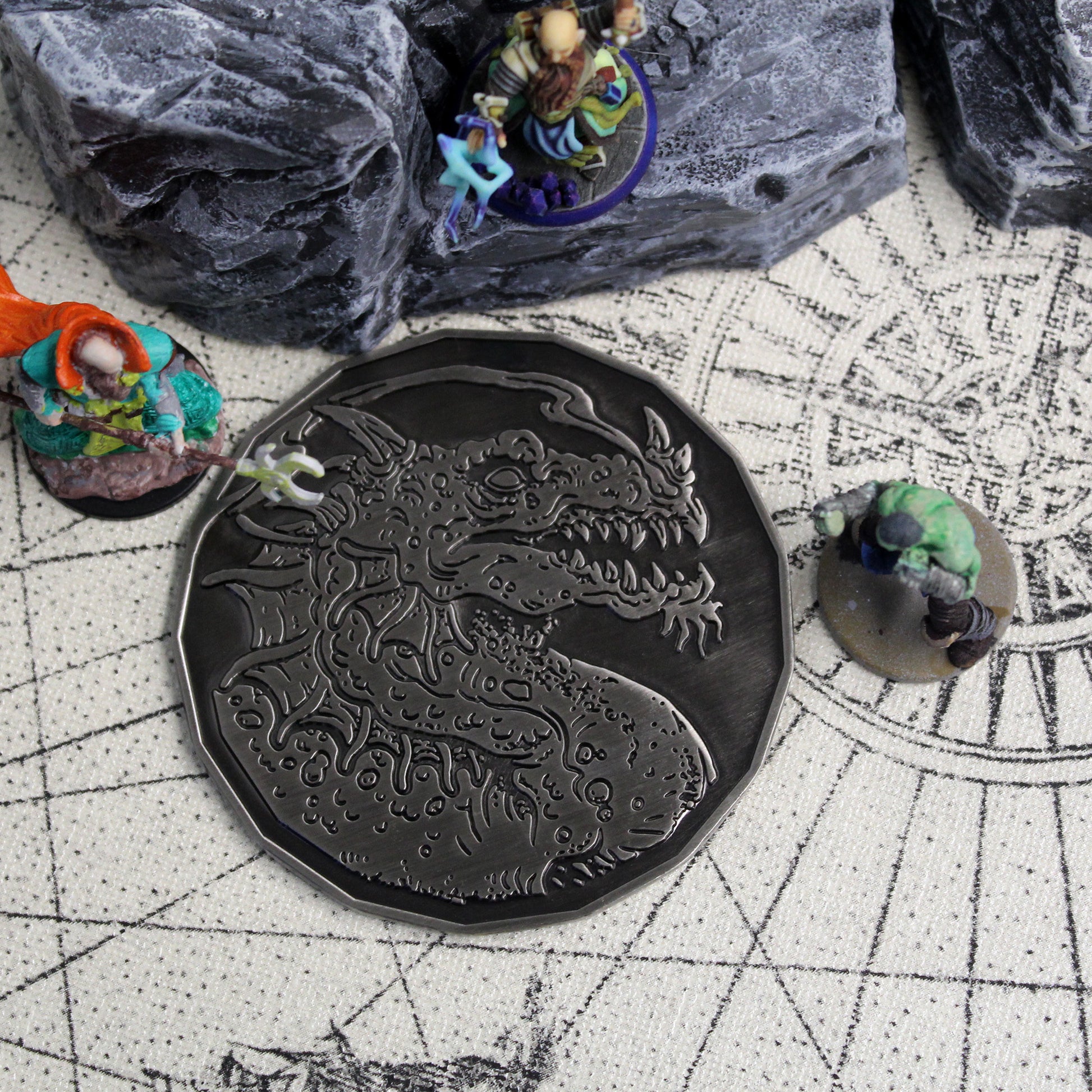 Smoke Dragon token on a rustic map with scattered miniatures, emphasizing the premium silver finish and its practical use in D&D sessions.