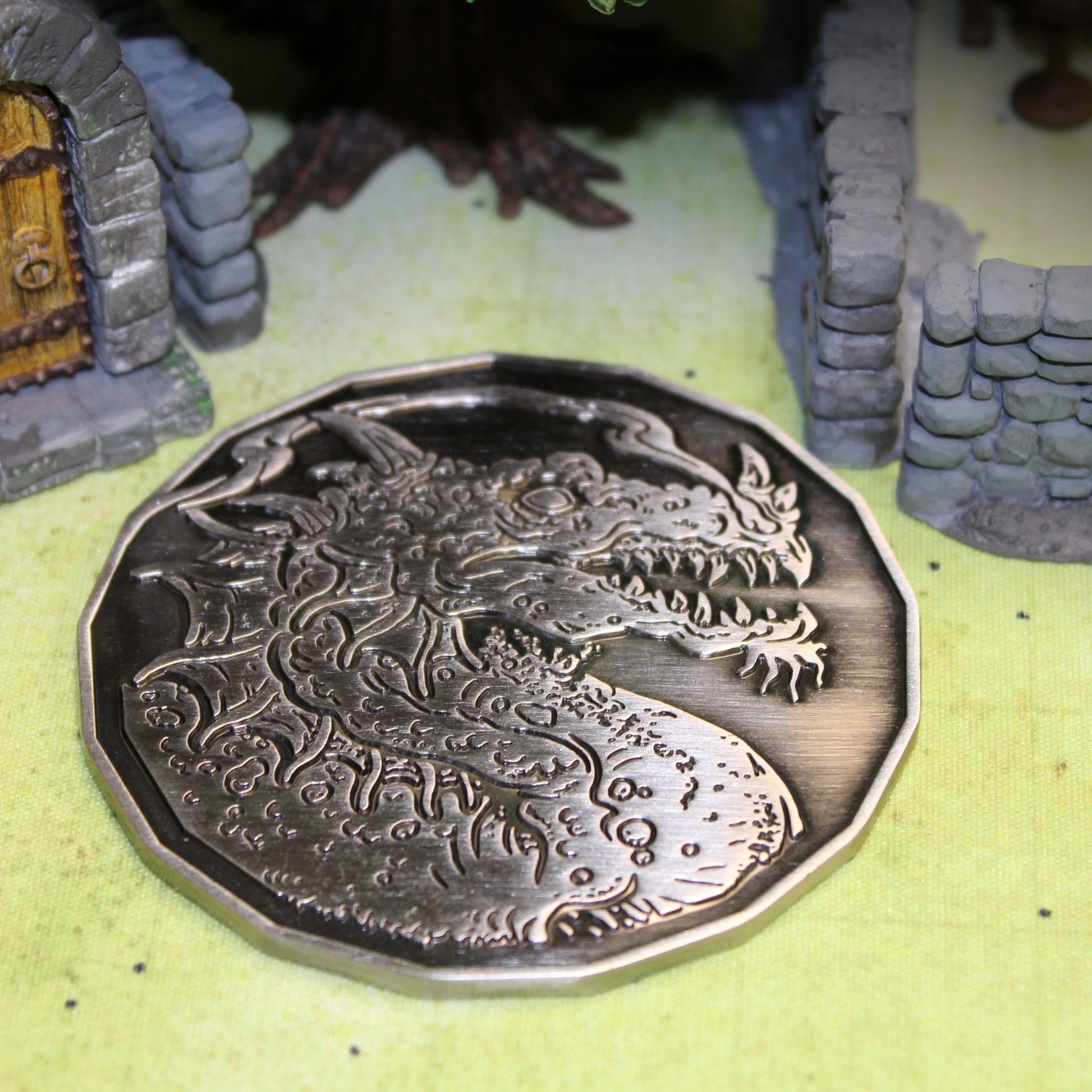Adult Smoke Dragon monster token in antique silver displayed on a detailed battlemap, surrounded by scatter terrain, emphasizing its use in dynamic D&D encounters.