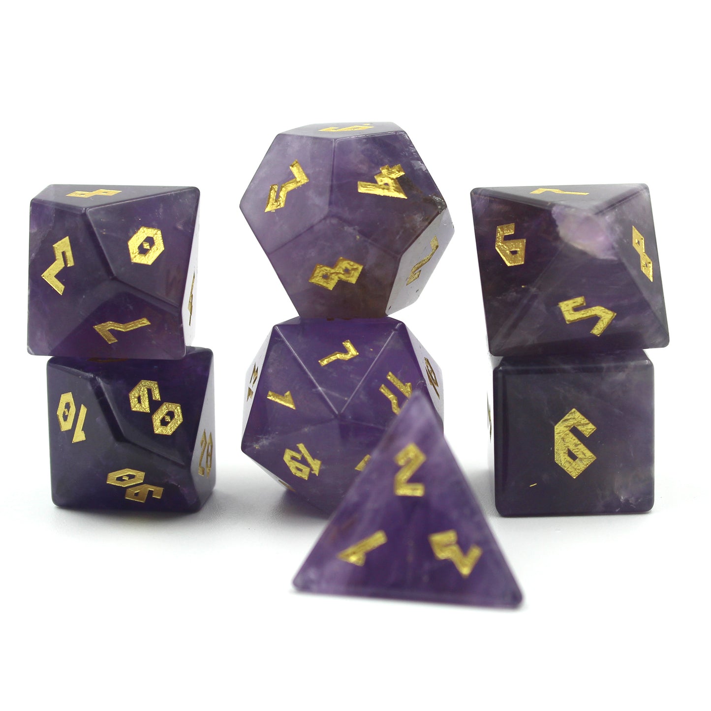 Close-up of Amethyst dice set on a white background, emphasizing the natural stone texture and the engraved gold-color Roman numerals.