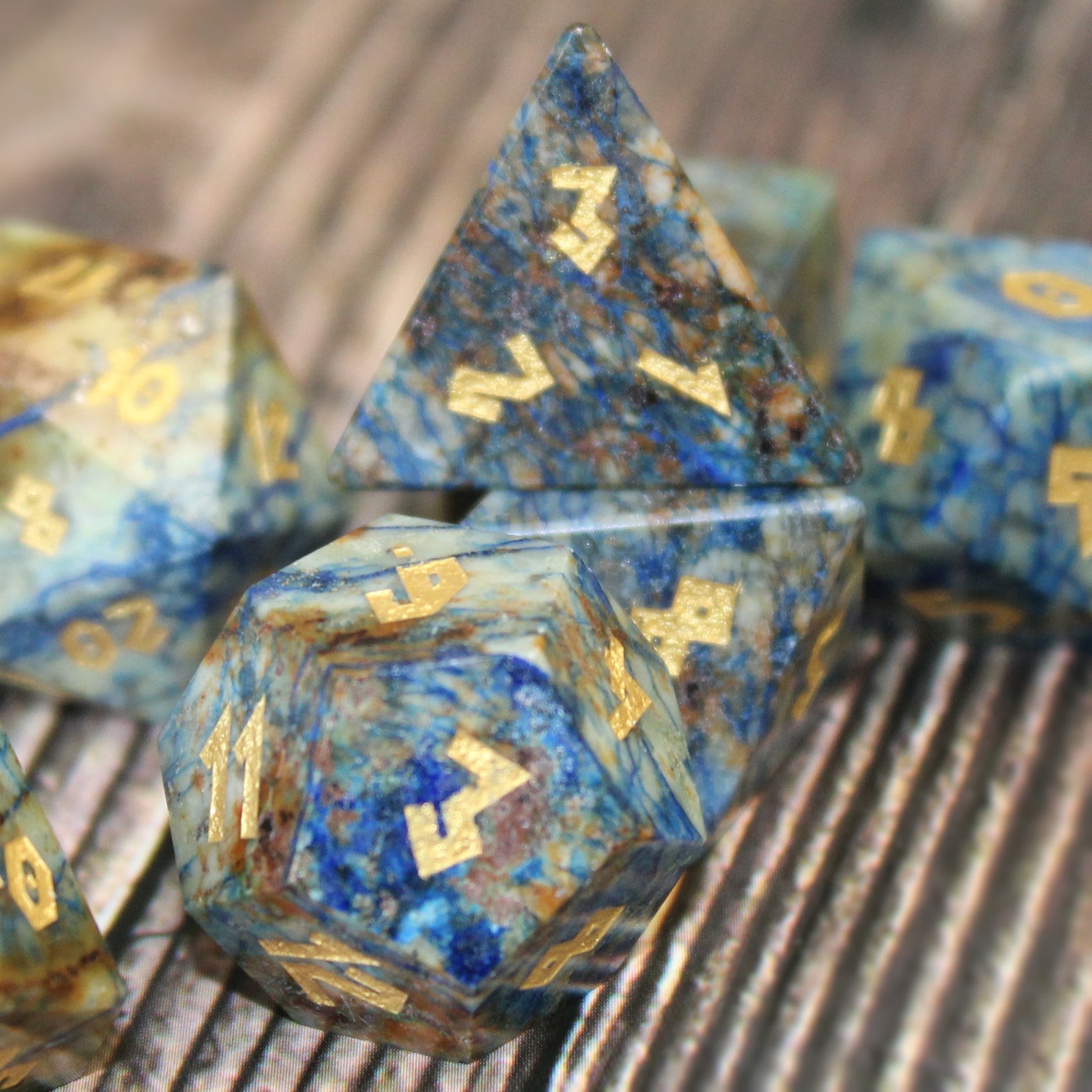 Azurite dice set scattered on a wooden surface