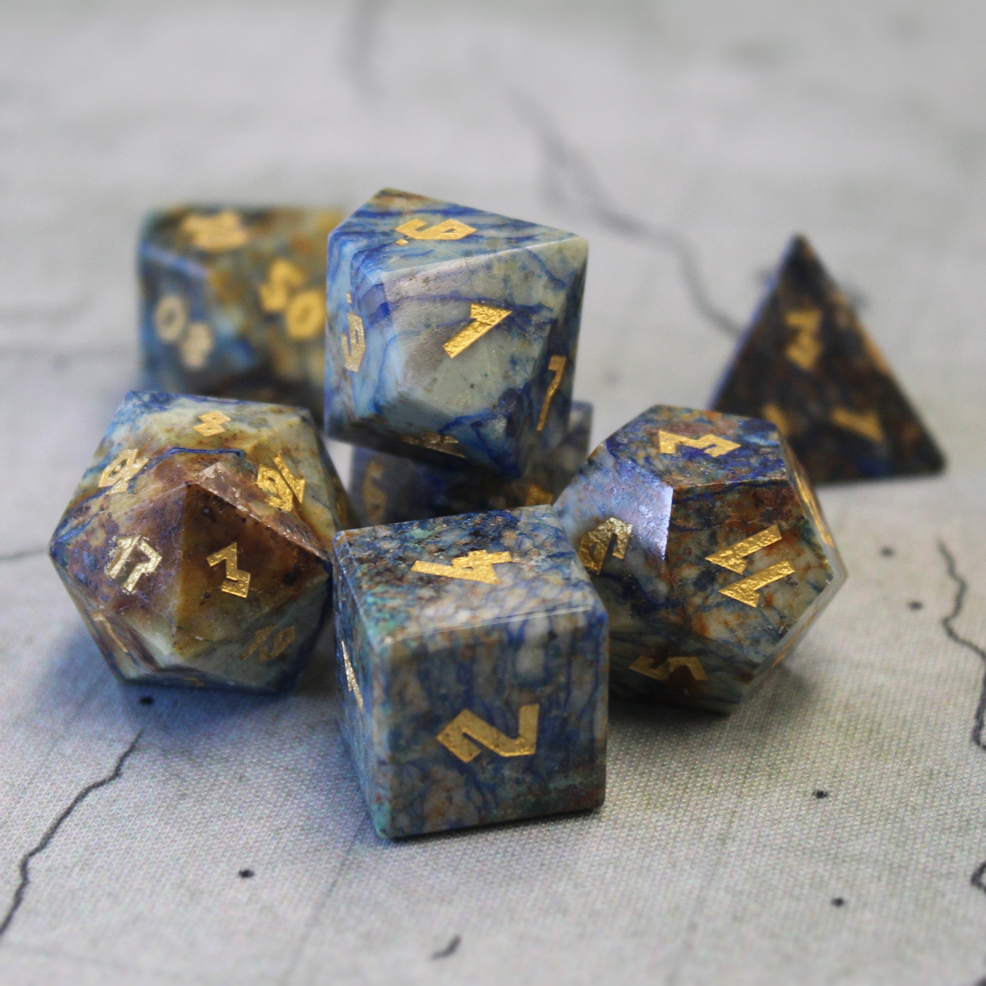 Azurite dice set scattered on a play mat