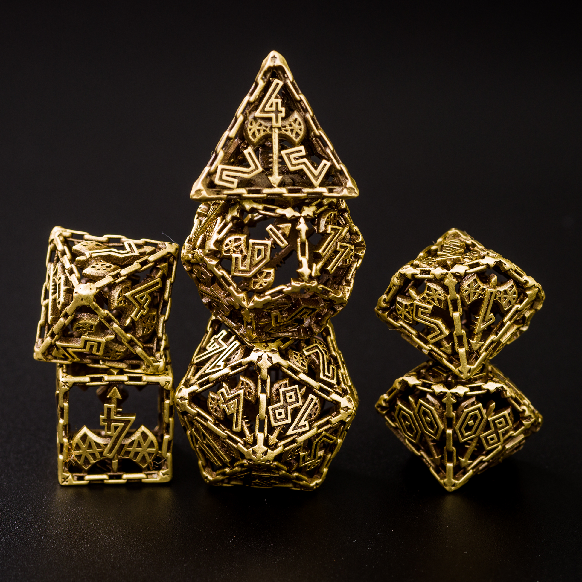 Bronze Barbarian Cage Dice Set on a black background, showing the intricate hollow design, with the highest numbers represented by crossed war hammer and battle axe.