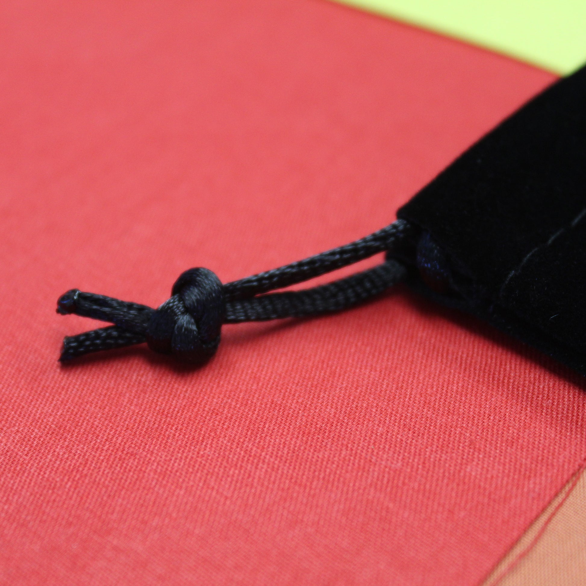 Closup of drawstring for dice dungeon dice bag. Tied at the end.