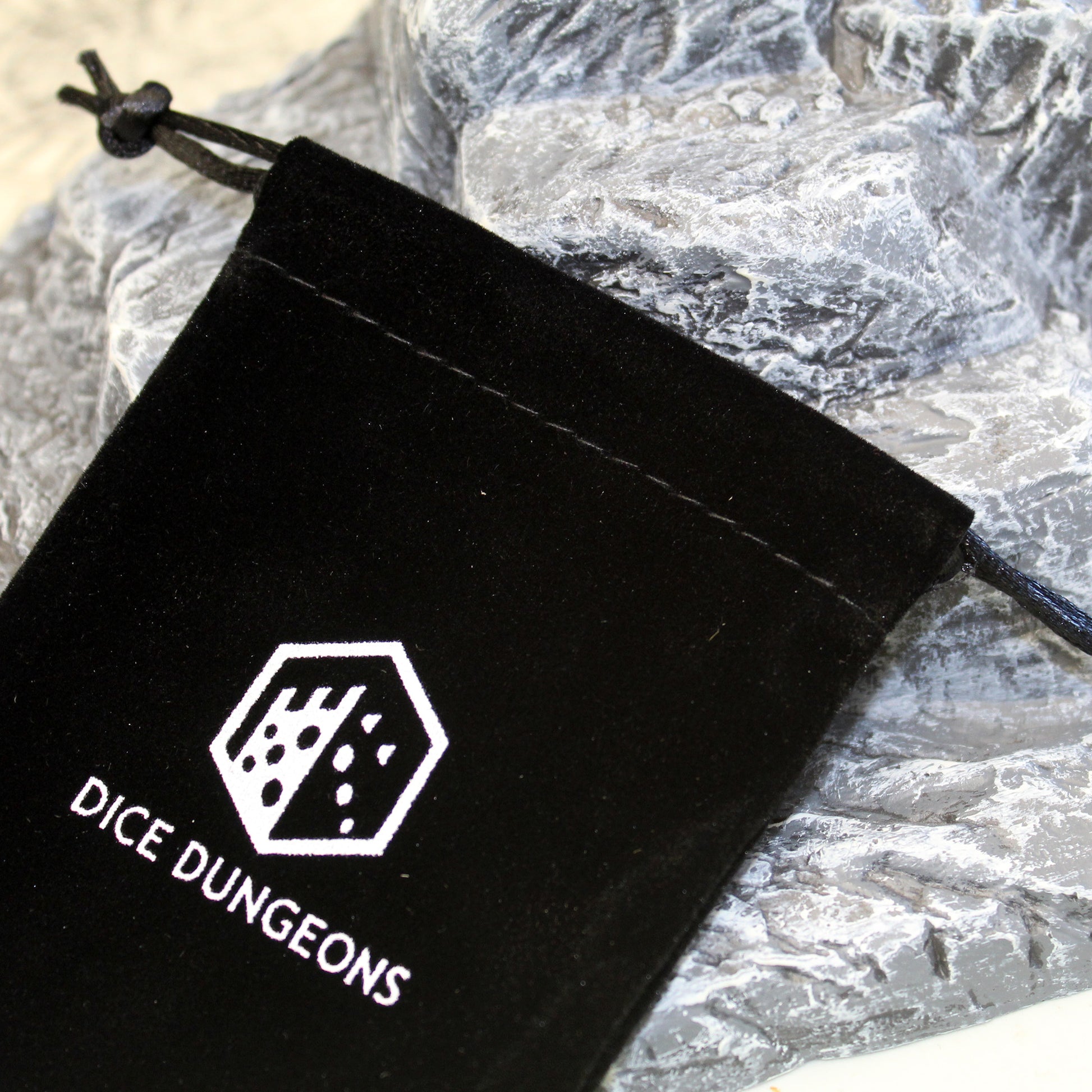 Dice Dungeons dice bag holds around 3 dice sets.