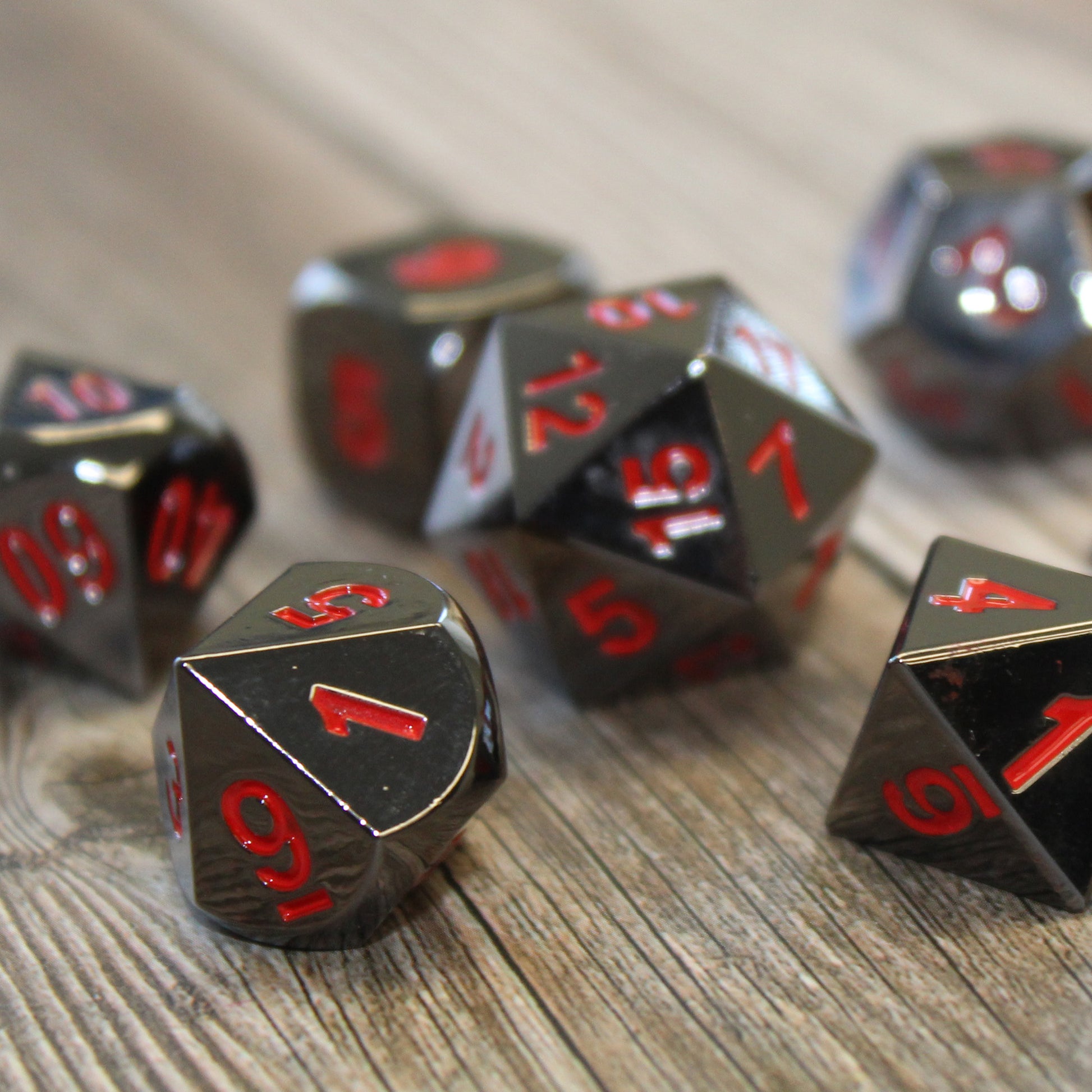 Metal Dice Set in black nickel base with red numbering.