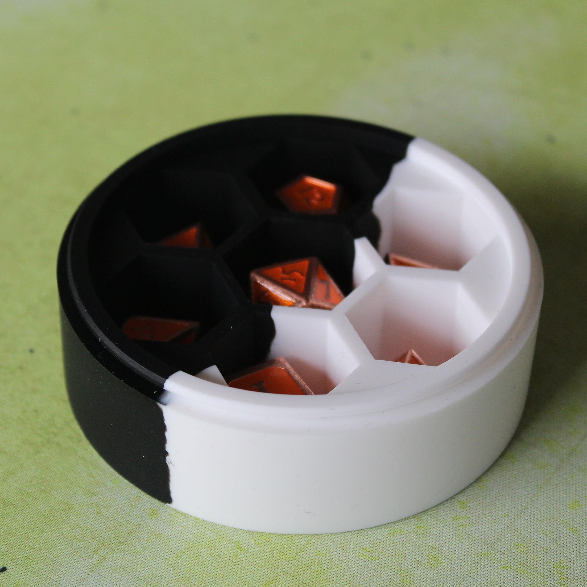 Round Dice Case holding a full set of dice, showcasing its secure compartments designed to protect your most prized dice sets.