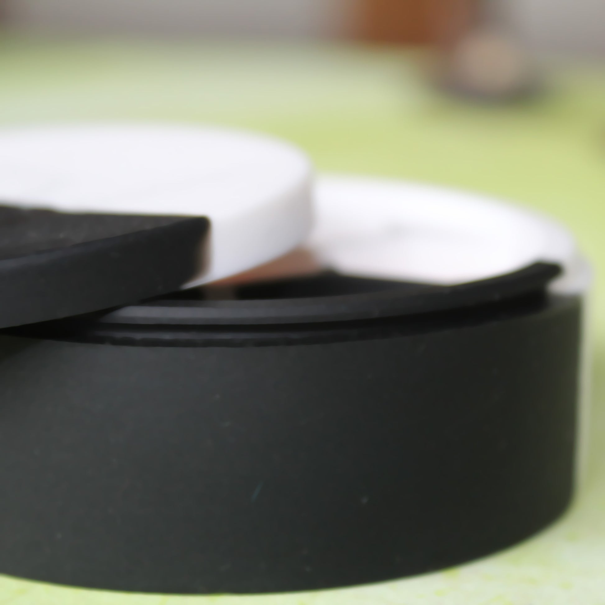 Close-up of the Silicone Round Dice Case on a table, focusing on the flexible lipped edge that securely holds the case shut when fully closed.