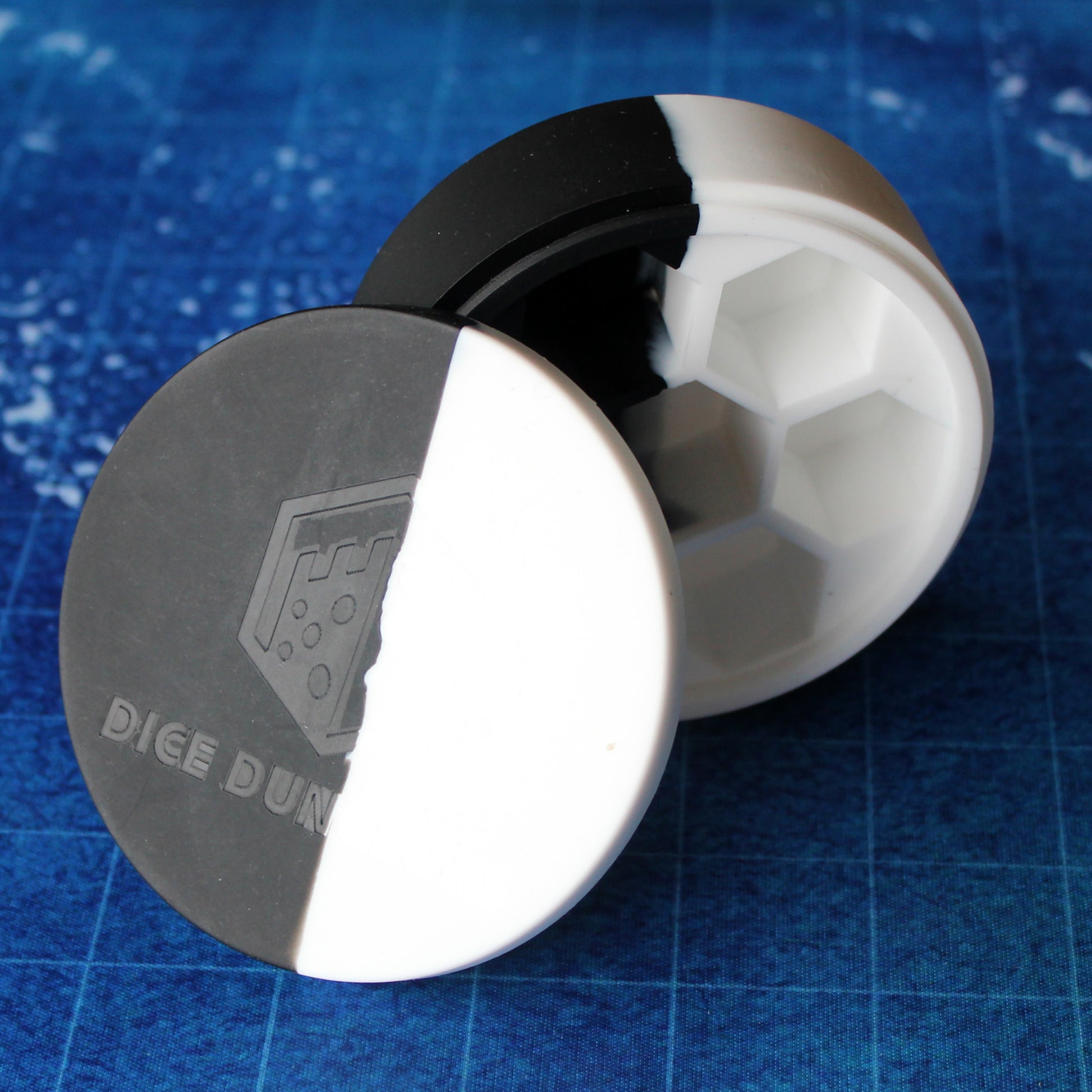 Open Silicone Round Dice Case standing upright, displaying deep individual slots for securely holding each die in a 7-piece set.