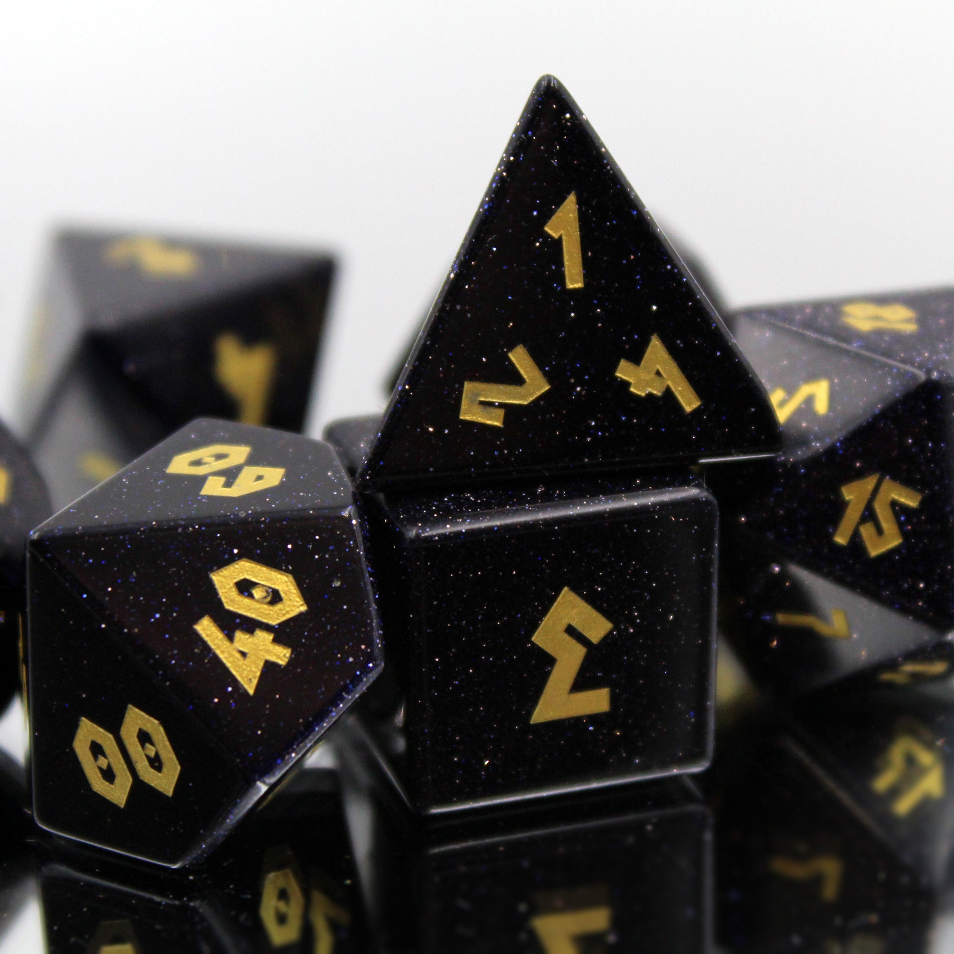 Zoomed in of the Blue Goldstone Dice Set, with sparkling blue stone.