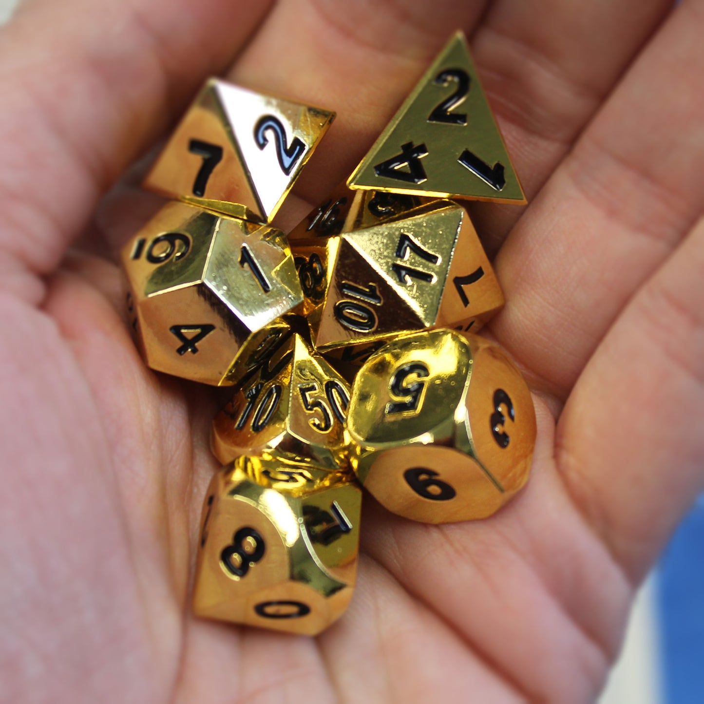 Metal Bright Gold Dice Set held in a hand, highlighting sturdy and heavy feel ideal for RPG gamers.