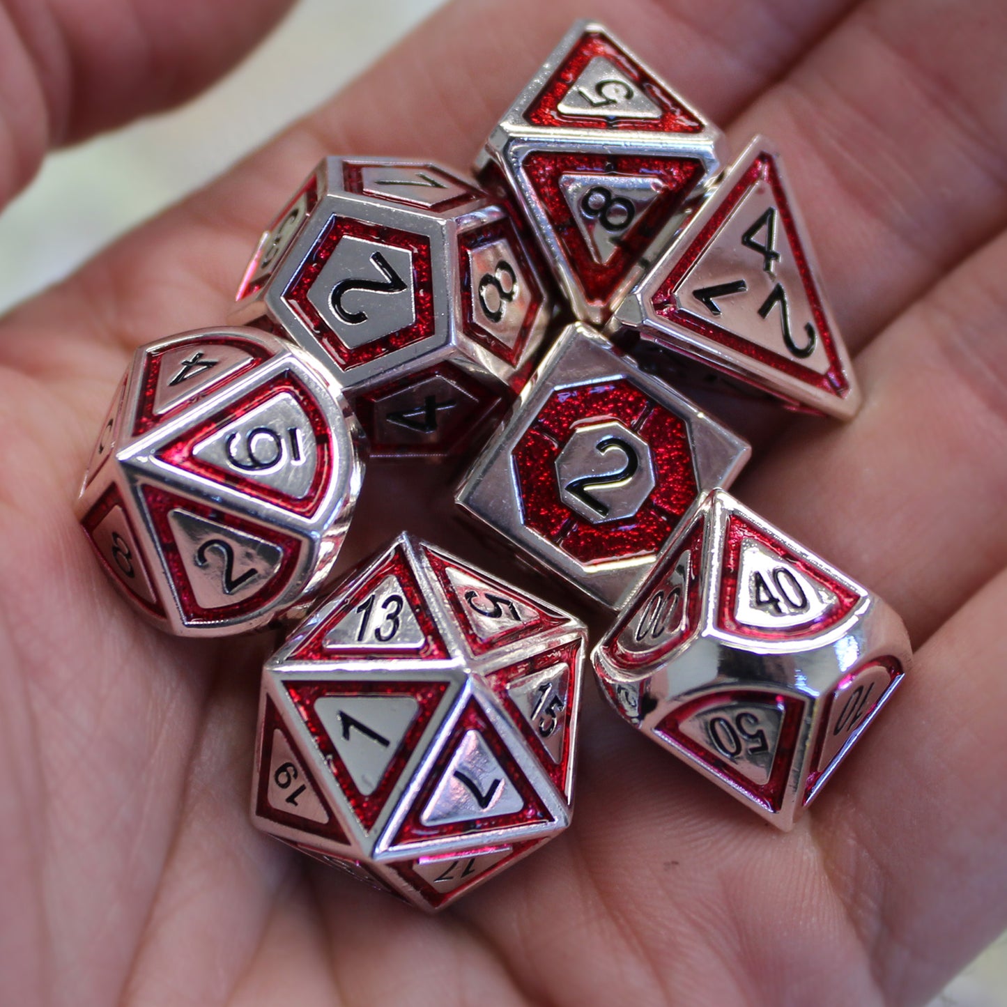 Metal BullsEye red dice set in the palm of a person's hand