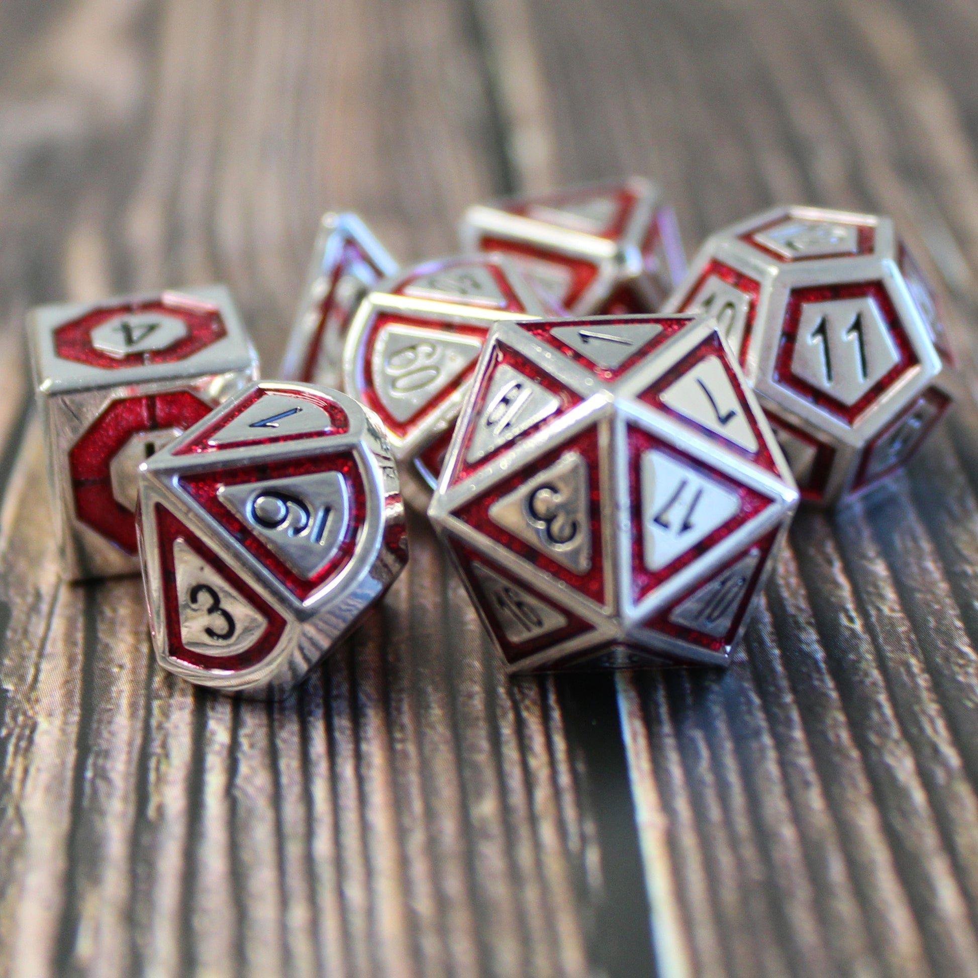 Metal BullsEye red dice set arranged on top of a wooden surface